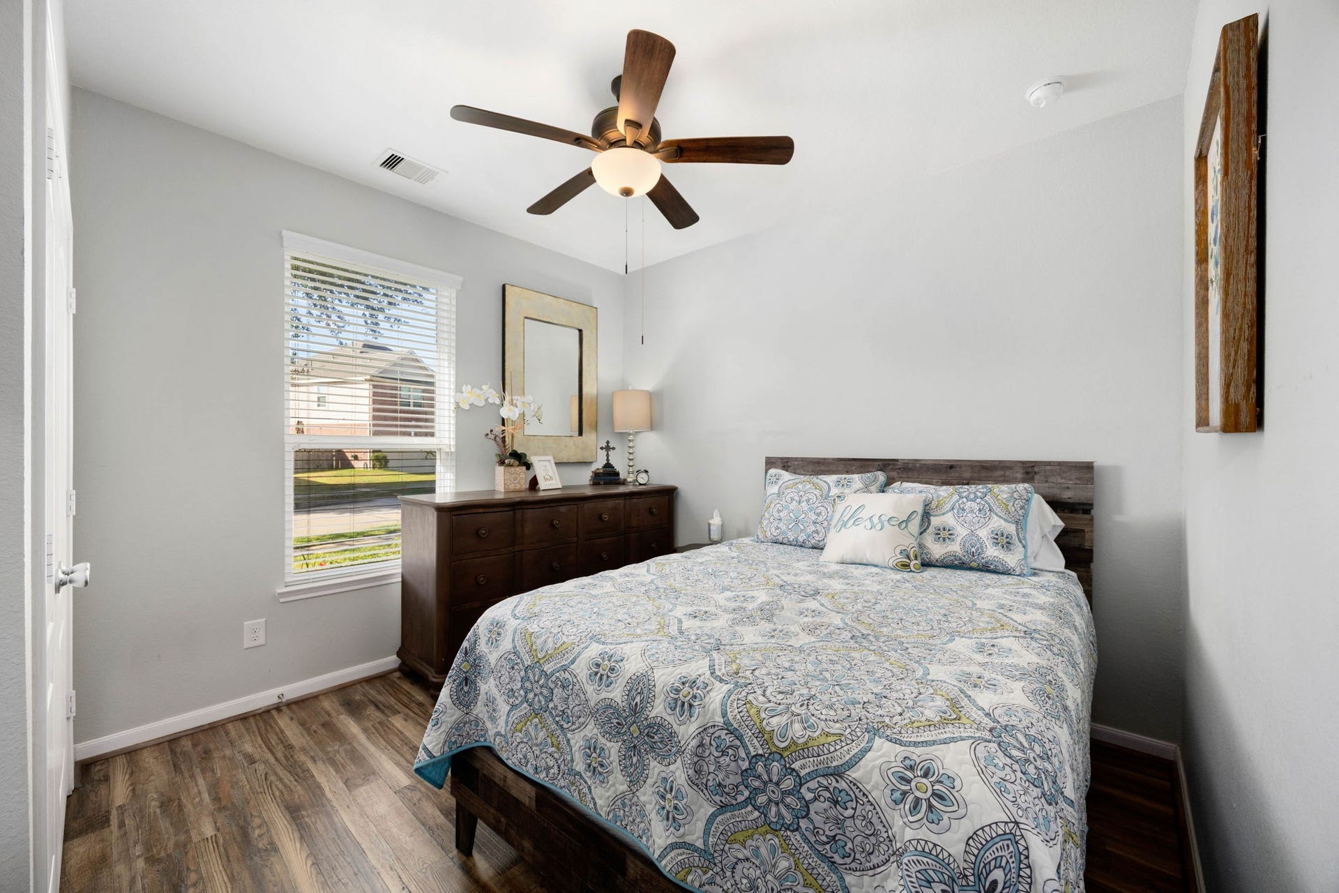 24114 Buffalo Cove Lane, Katy, TX 77493 This secondary bedroom features a ceiling fan and a large window overlooking the front yard.