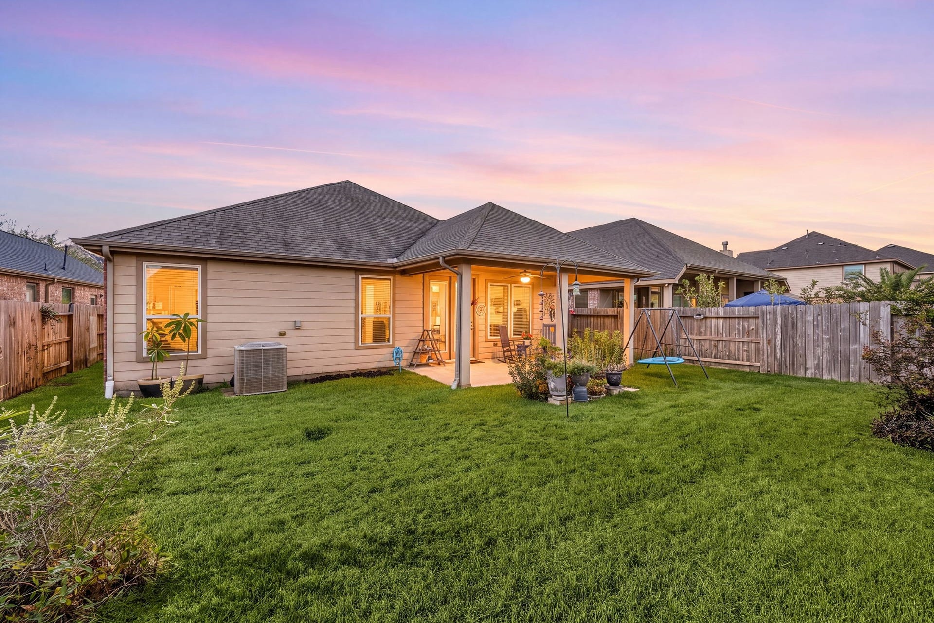 24114 Buffalo Cove Lane, Katy, TX 77493 The twilight view shows how the covered patio and backyard extend the home's living space outdoors.