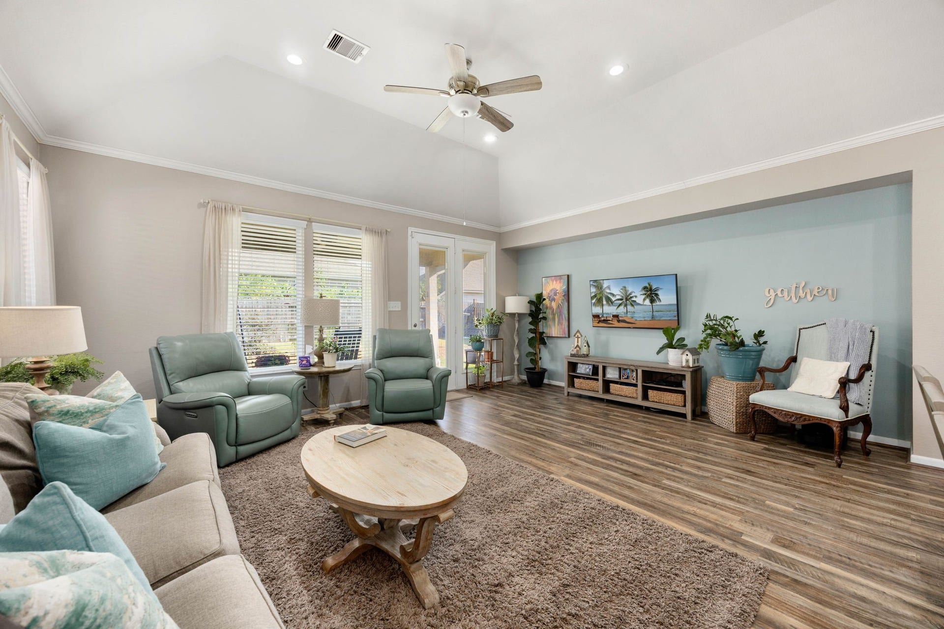 24114 Buffalo Cove Lane, Katy, TX 77493 The spacious living room offers a vaulted ceiling, ceiling fan, and abundant natural light, with French doors opening directly to the backyard.