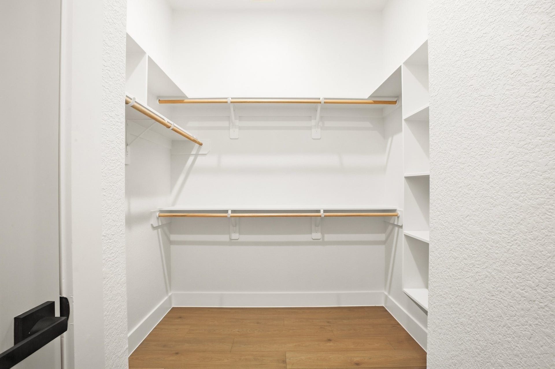 Custom walk-in closet with built-in shelving and ample storage.