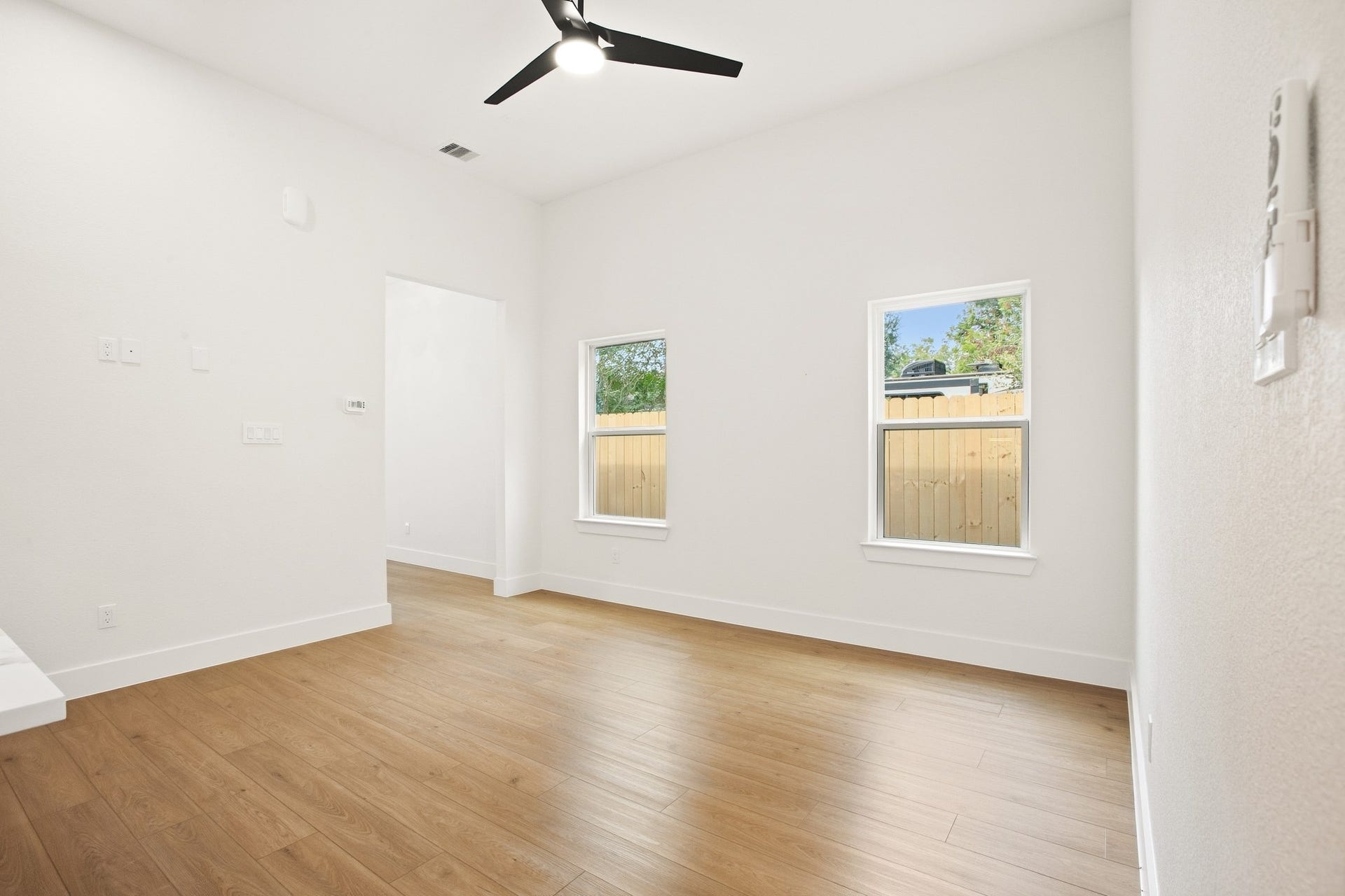 Bright flex space with warm wood flooring and natural light.