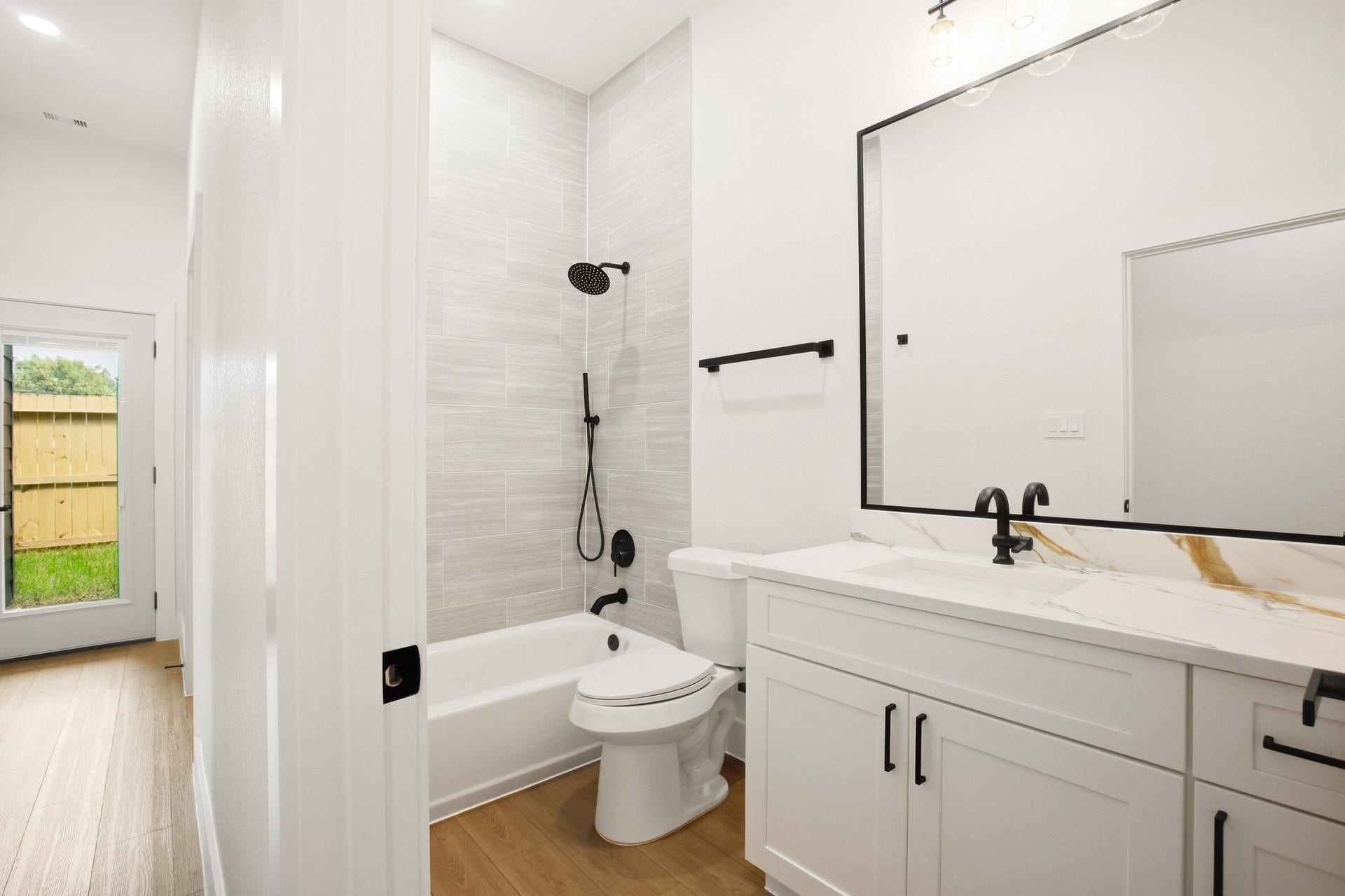 Contemporary bath with a spacious vanity and glass-enclosed shower.