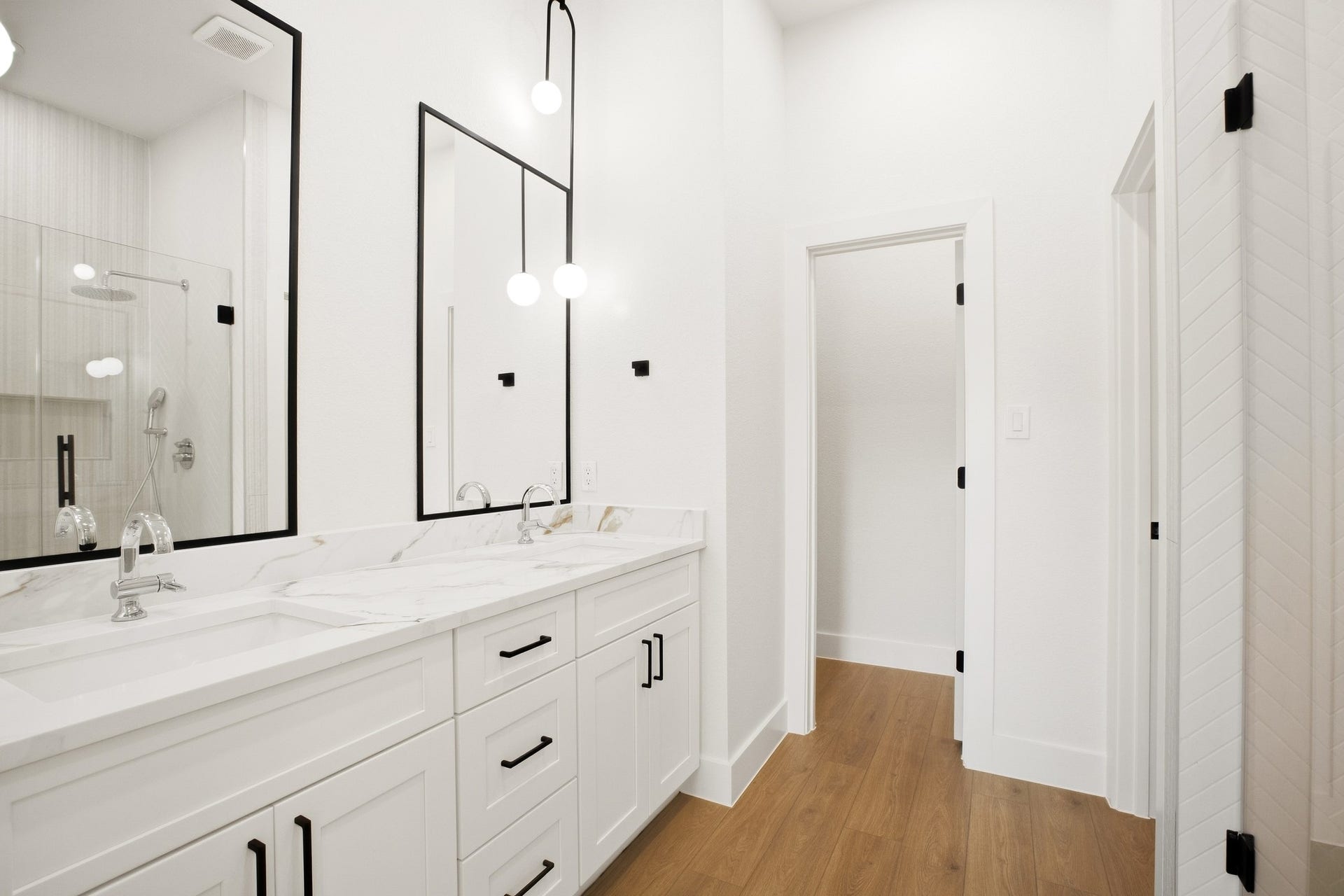 Bright bath with a sleek vanity and contemporary finishes.