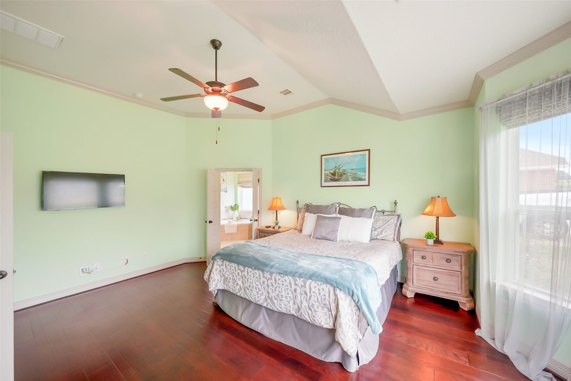 230 Lawrence Marshall Drive, Hempstead, TX 77445 Primary suite featuring hardwood floors, a tray ceiling, and a spacious en-suite bathroom