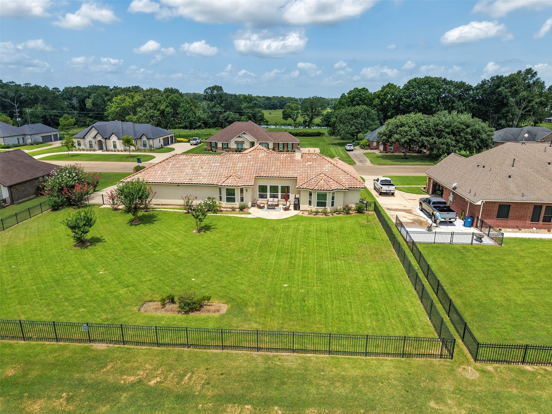 230 Lawrence Marshall Drive, Hempstead, TX 77445 "Rear aerial view showcasing the expansive, fenced backyard, spacious homesite, and beautifully maintained lawn