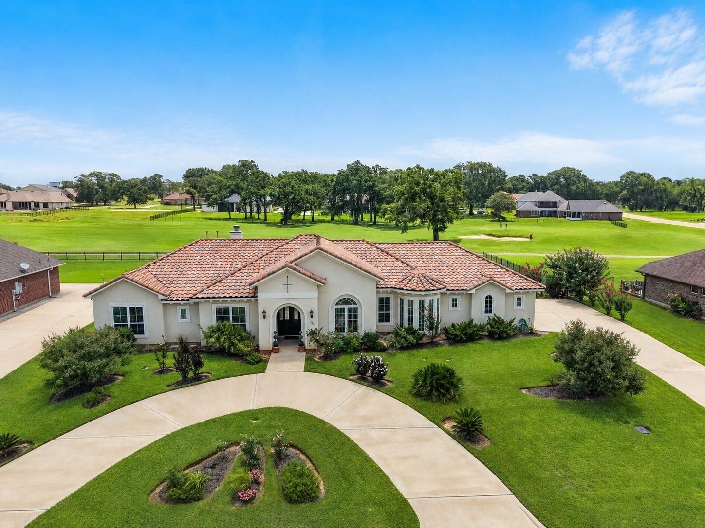 230 Lawrence Marshall Drive, Hempstead, TX 77445 Elegant custom Mediterranean home with a grand circular driveway and beautiful golf course frontage in gated Legendary Oaks.