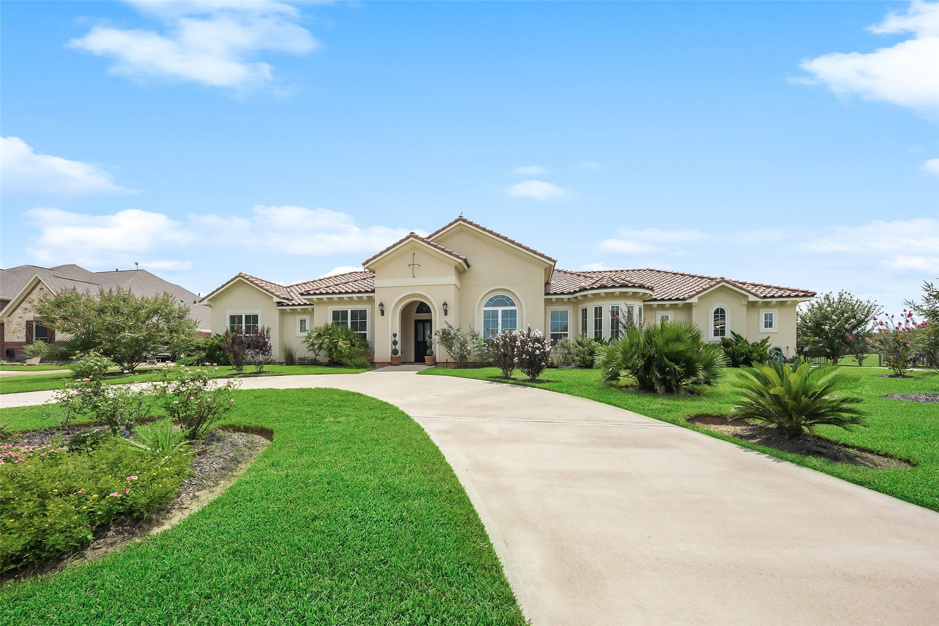 230 Lawrence Marshall Drive, Hempstead, TX 77445 Welcoming front elevation featuring a sweeping circular driveway, manicured landscaping, and a covered front entry