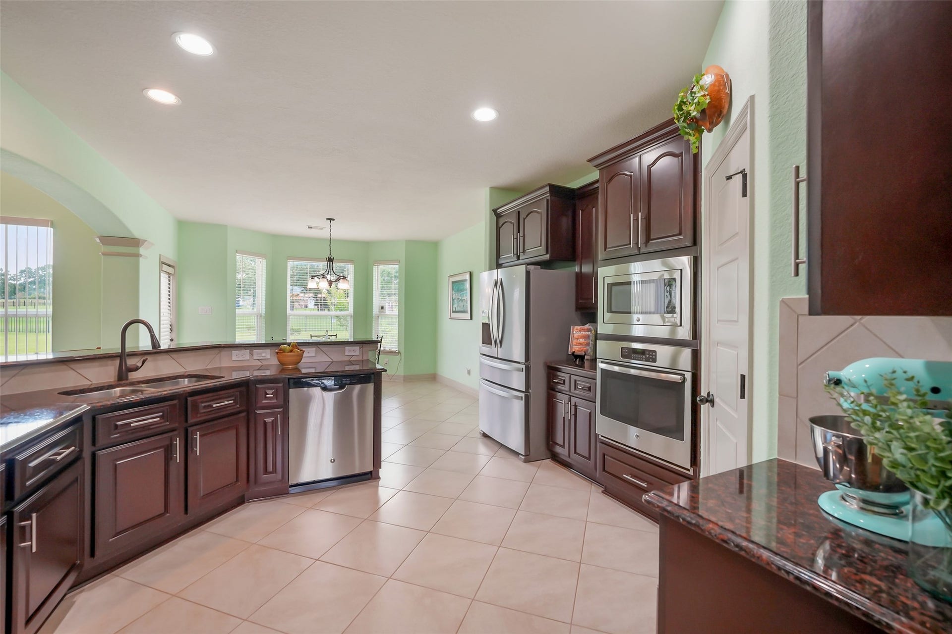 230 Lawrence Marshall Drive, Hempstead, TX 77445 Open-concept kitchen featuring granite countertops, custom wood cabinetry, a center island, and abundant storage