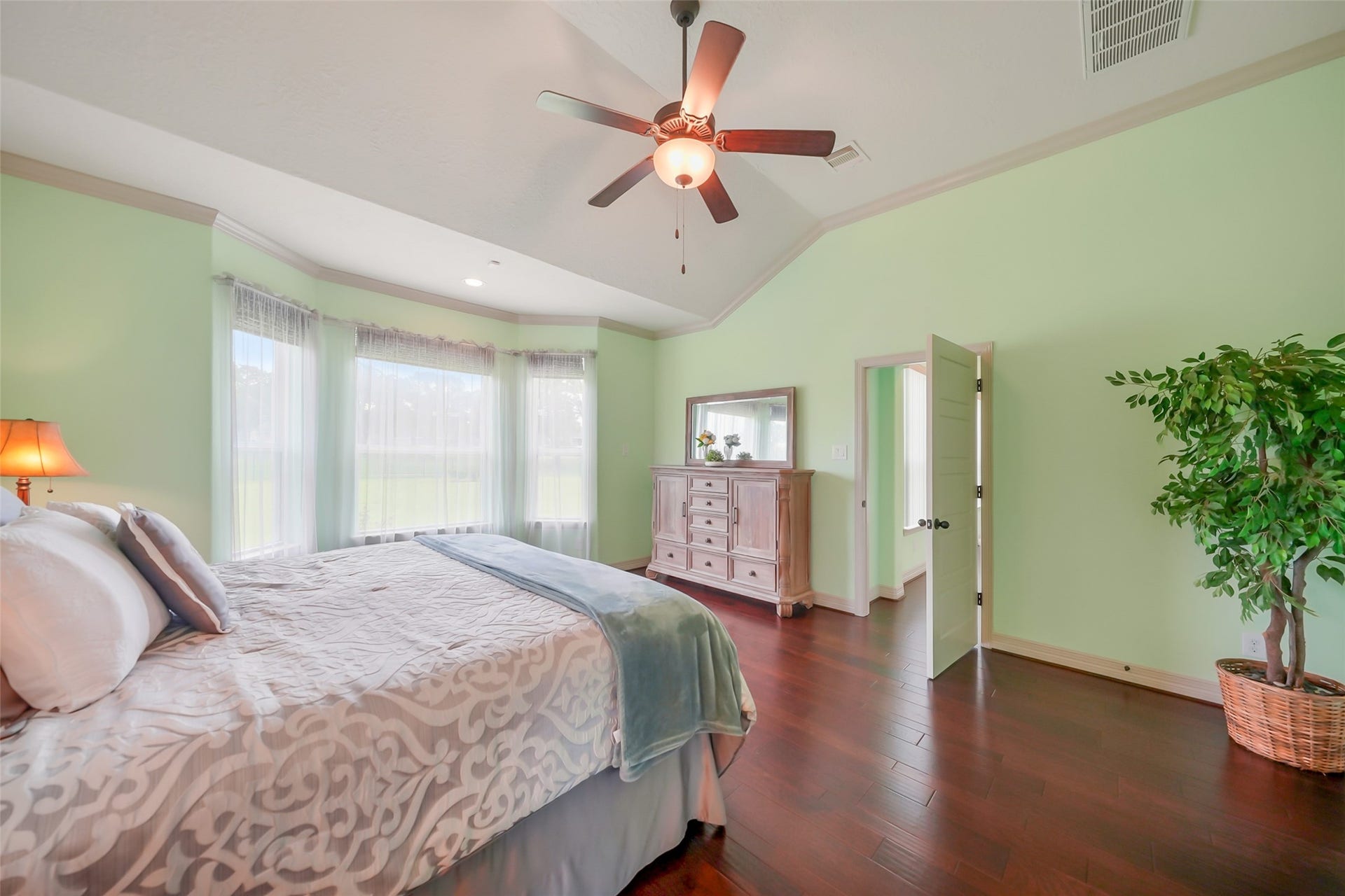 230 Lawrence Marshall Drive, Hempstead, TX 77445 Spacious primary bedroom featuring hardwood floors, expansive windows, and abundant natural light