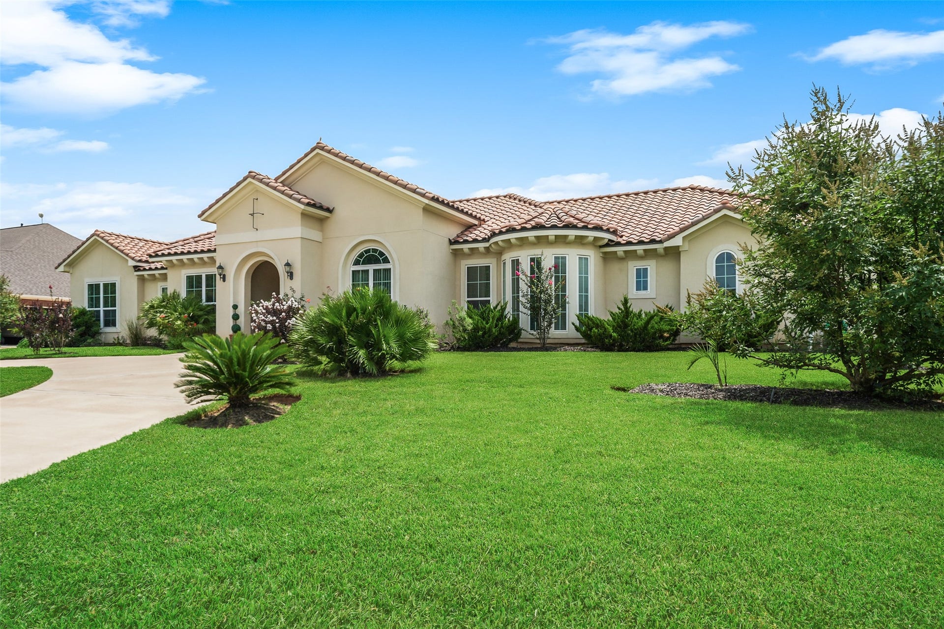 230 Lawrence Marshall Drive, Hempstead, TX 77445 Wide front view showcasing the home's beautifully maintained landscaping, expansive lawn, and inviting curb appeal.