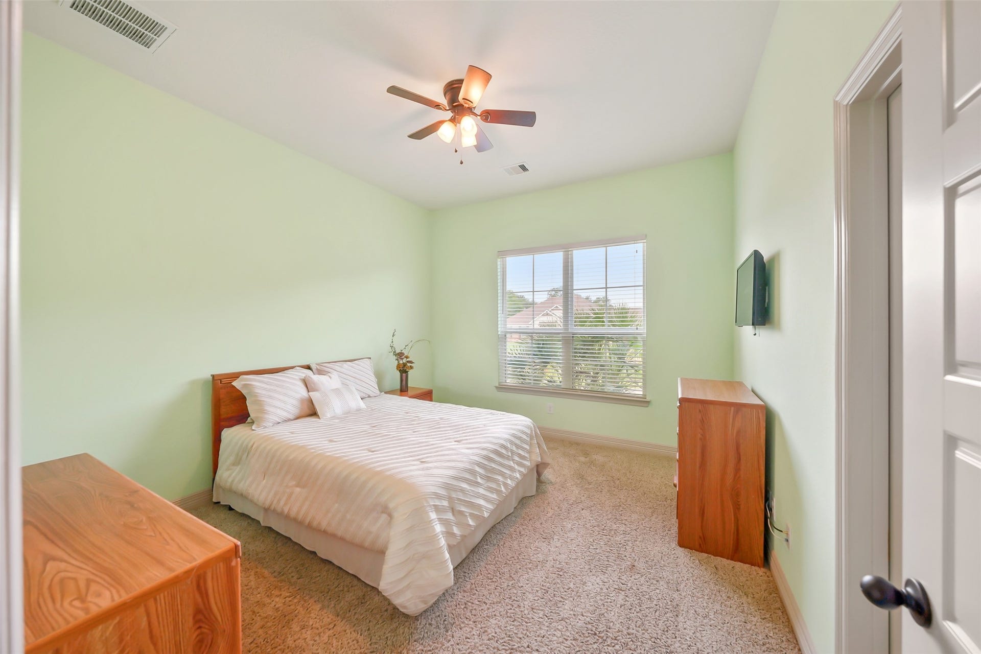 230 Lawrence Marshall Drive, Hempstead, TX 77445 Bright secondary bedroom featuring hardwood floors, a ceiling fan, and abundant natural light.