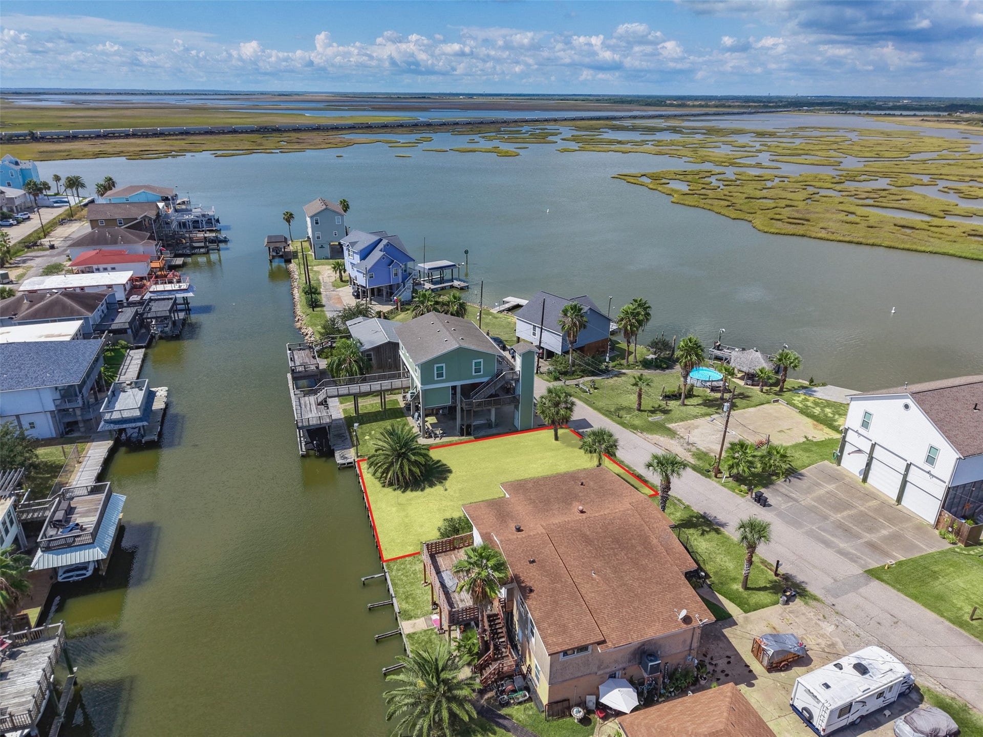 65 Lakeside Drive, Hitchcock, TX 77563 The lot outlined from above. It sits a few lots from the end of Lakeside Drive with the canal along the back; follow it out for quick access to Jones Bay and the Galveston Bay system. Newer homes on both sides.