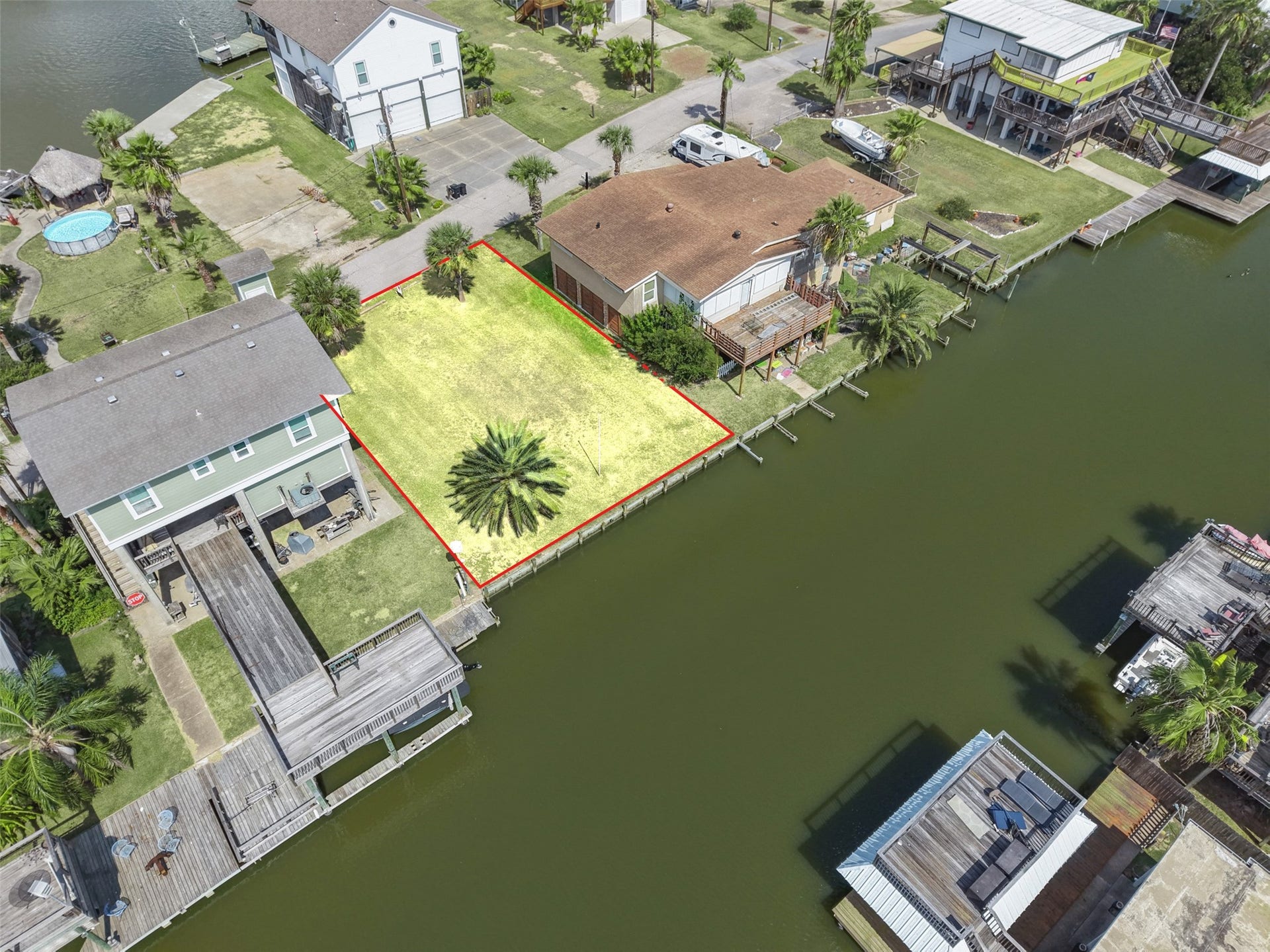 65 Lakeside Drive, Hitchcock, TX 77563 Angled overhead with the lot centered between its neighbors. Both homes beside it are recent builds. No HOA!