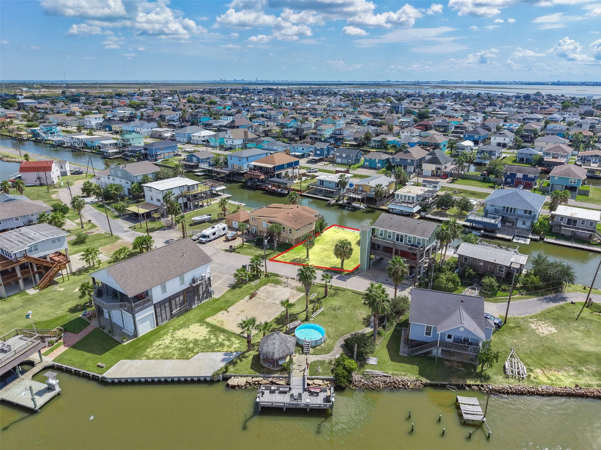 65 Lakeside Drive, Hitchcock, TX 77563 One more wide aerial: canals, rooftops and the bay beyond. Galveston Island State Park is about 9.0 miles away for beach days, and Moody Gardens is about 6.9.