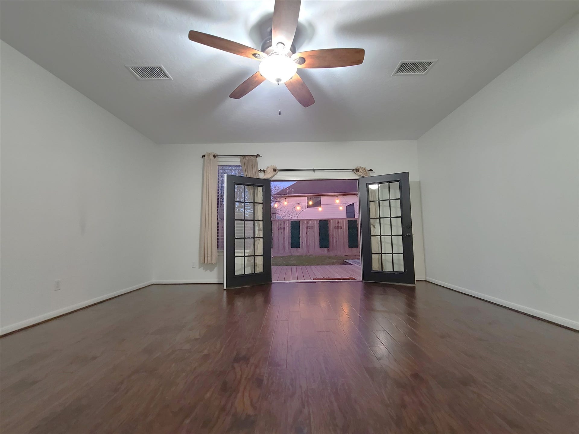 Master bedroom french doors lead to the backyard