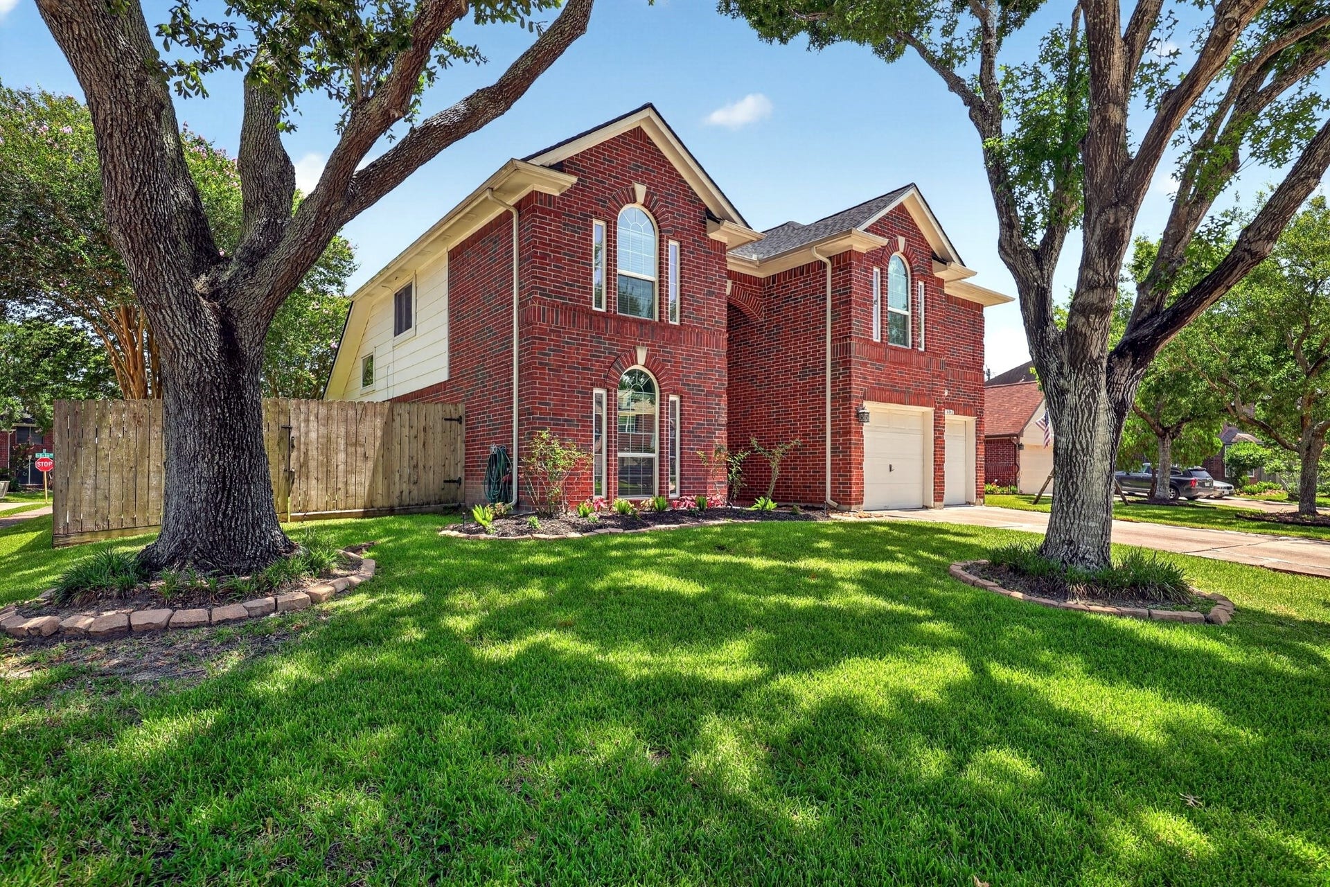 16003 Salton Point Drive, Friendswood, TX 77546 Beautiful corner-lot home with mature trees and inviting curb appeal.