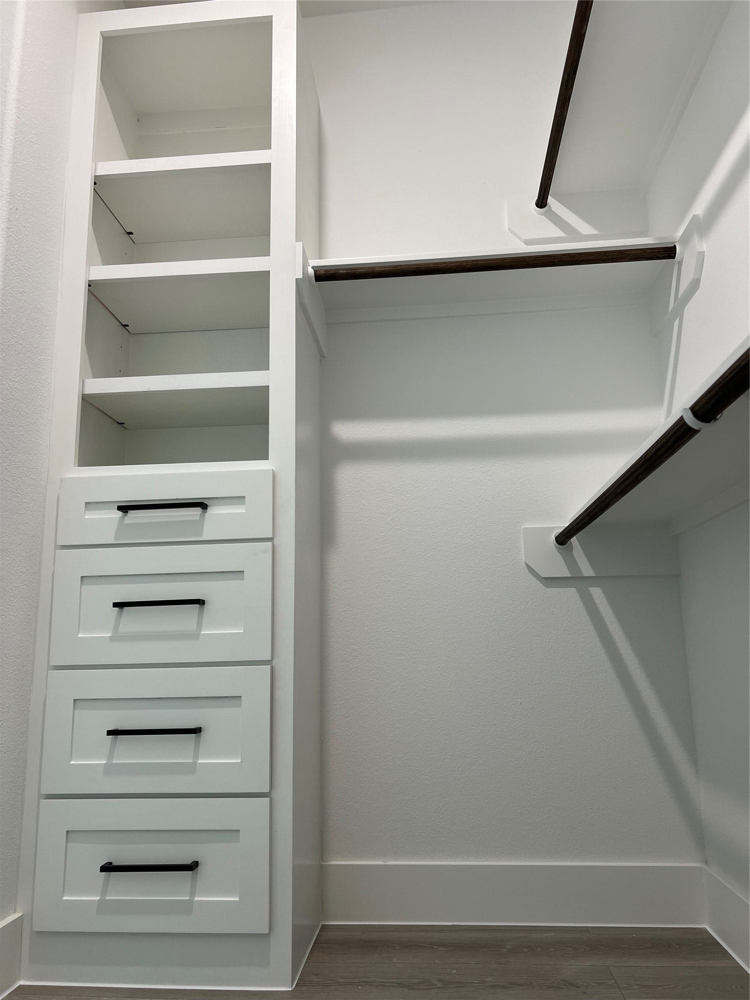 7107 Foster Street, #B, Houston, TX 77021 Spacious walk-in primary closet featuring built-in shelving, drawers, and ample hanging space for organized storage.