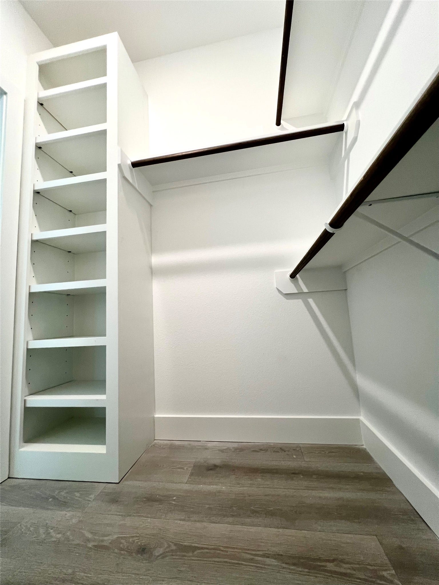 7107 Foster Street, #B, Houston, TX 77021 Spacious walk-in primary closet featuring custom shelving and ample hanging space for organized storage.