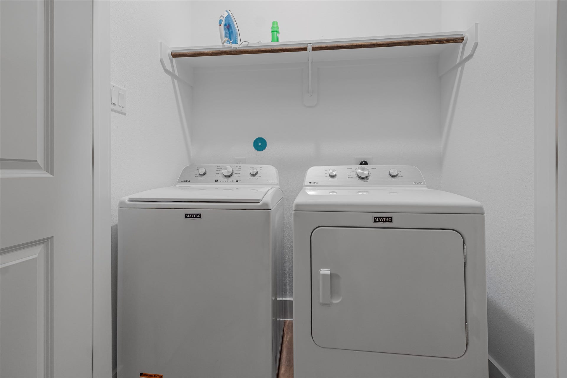 7107 Foster Street, #B, Houston, TX 77021 Convenient laundry space featuring a washer and dryer with an overhead shelf for storage.