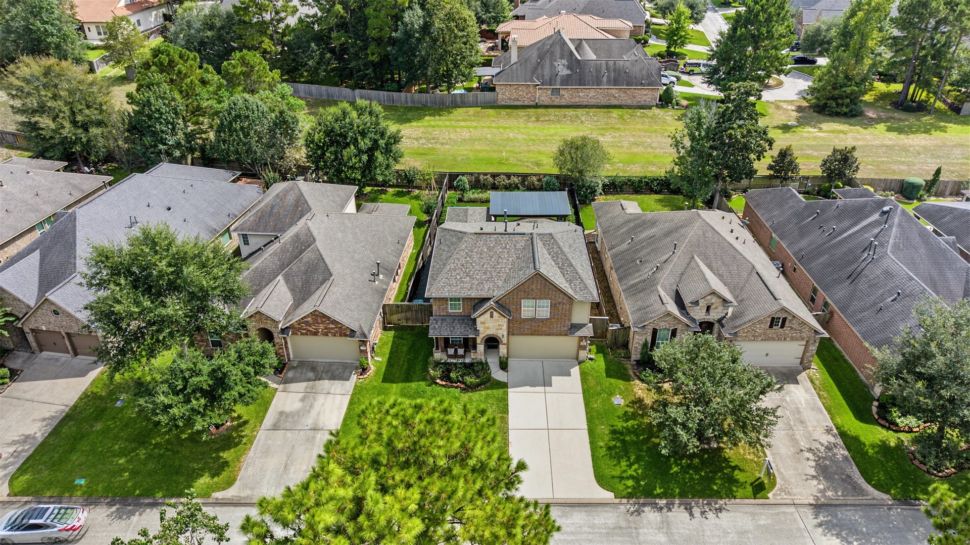 Charming two-story home backing to the greenbelt, featuring a spacious driveway, lush green lawn, and mature trees. Ideal for families seeking a serene suburban lifestyle.