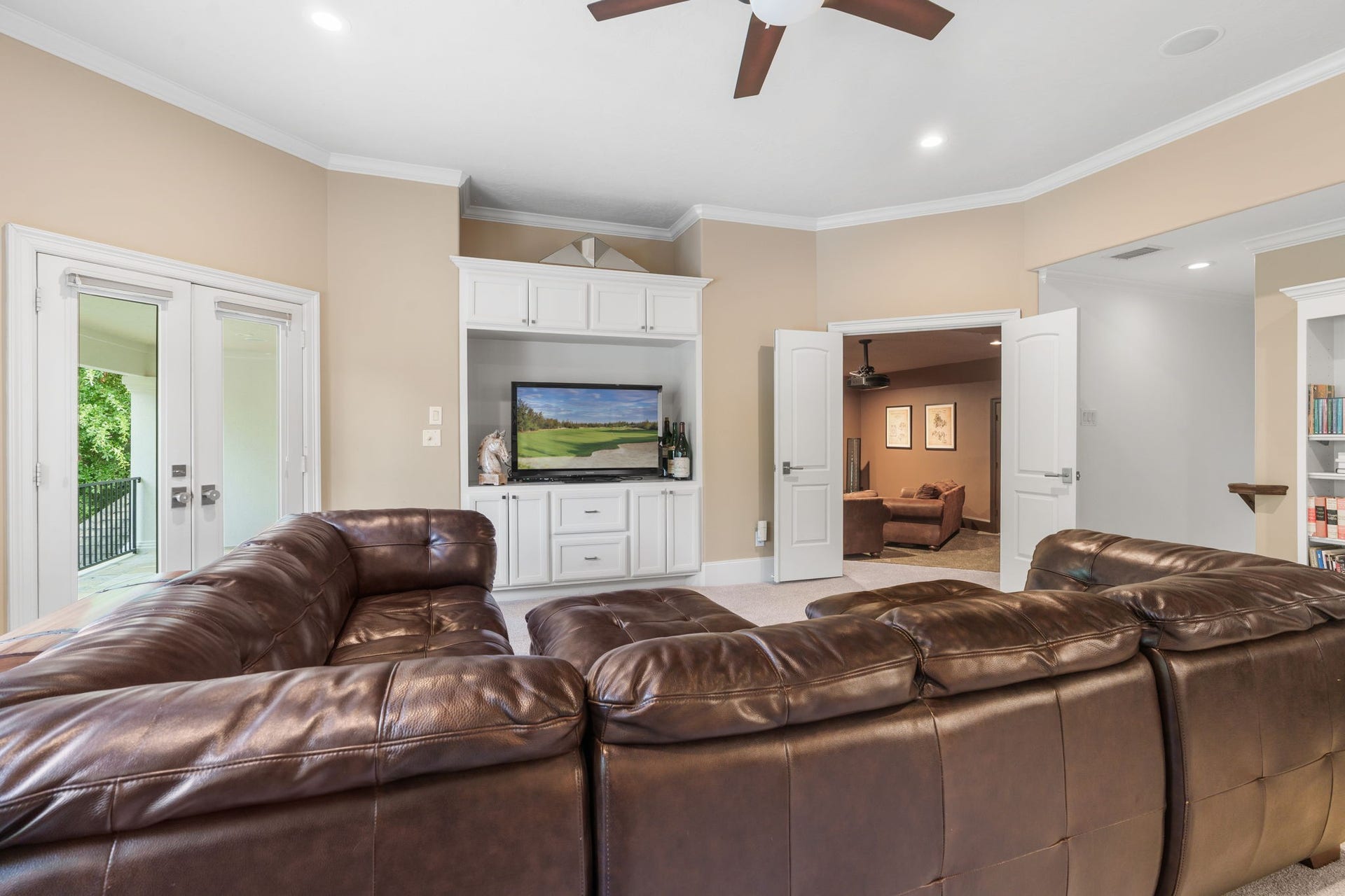 39 N Palmiera Circle, The Woodlands, TX 77382 Additional highlights include built-in storage, access to the oversized balcony with views of the backyard and pond. French doors open into the media / bonus room.