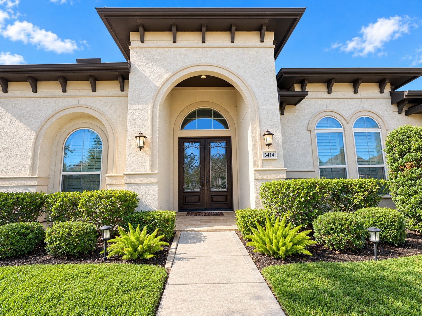 3414 Magnolia Shores Lane, Pearland, TX 77584 A closer look at the elegant front entrance, highlighting decorative ironwork and beautiful stucco finishes.