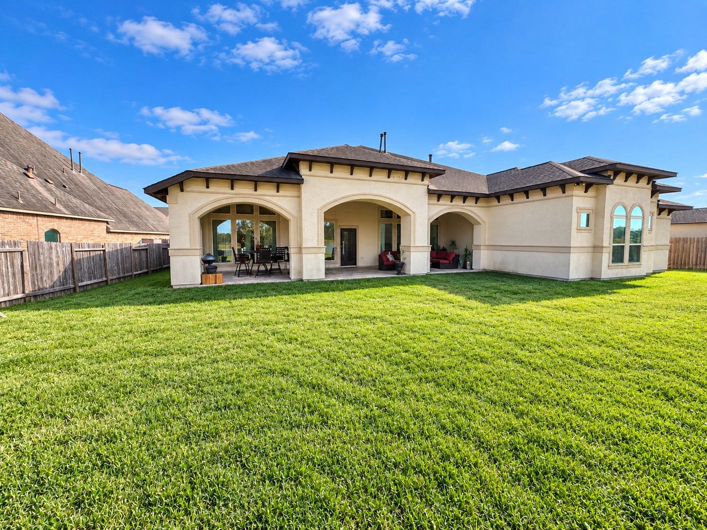 3414 Magnolia Shores Lane, Pearland, TX 77584 Spacious backyard with a covered patio, offering wonderful opportunities for outdoor entertaining.