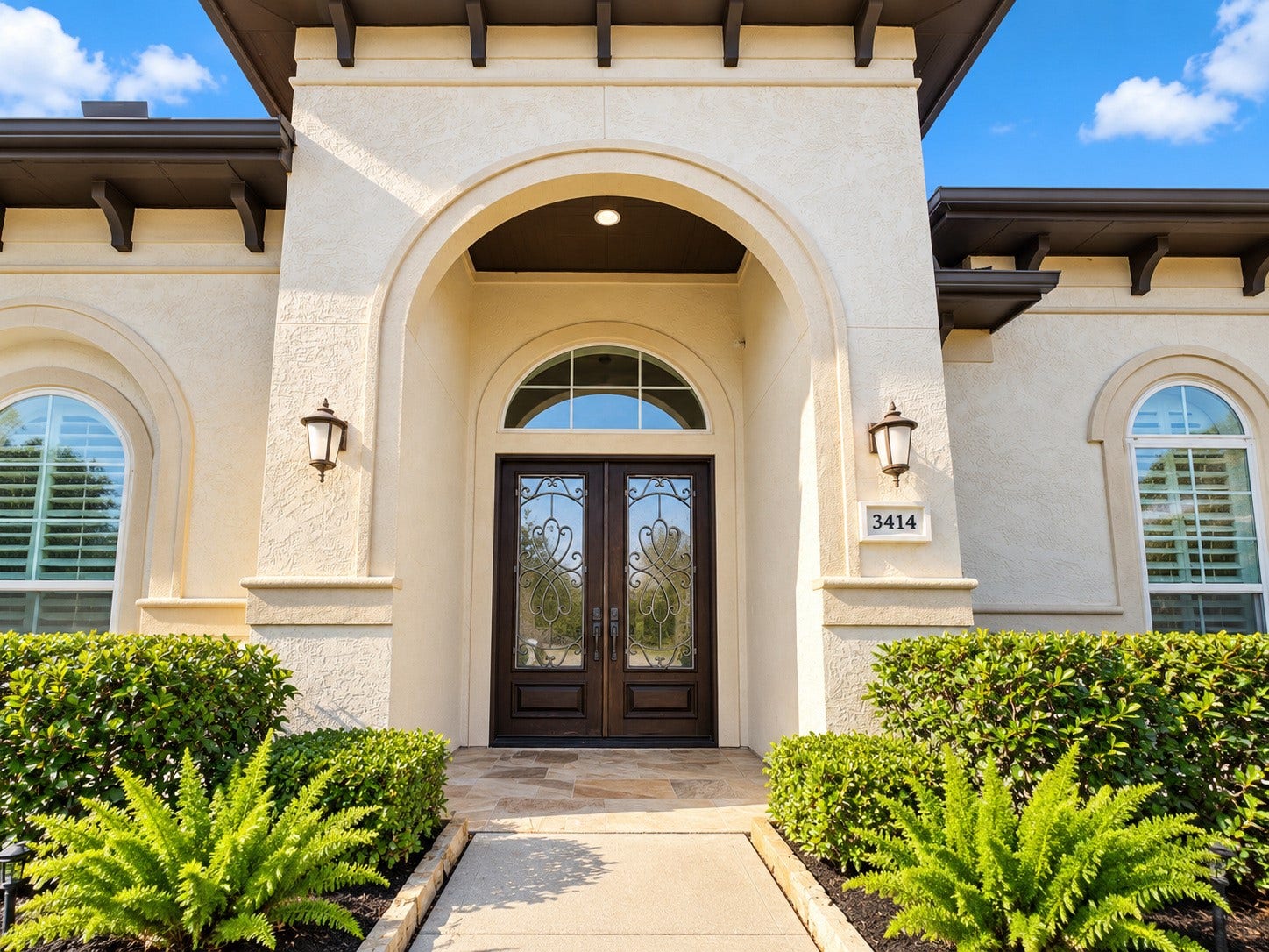 3414 Magnolia Shores Lane, Pearland, TX 77584 Stunning arched front entry featuring decorative double doors, architectural detailing, and attractive landscaping.