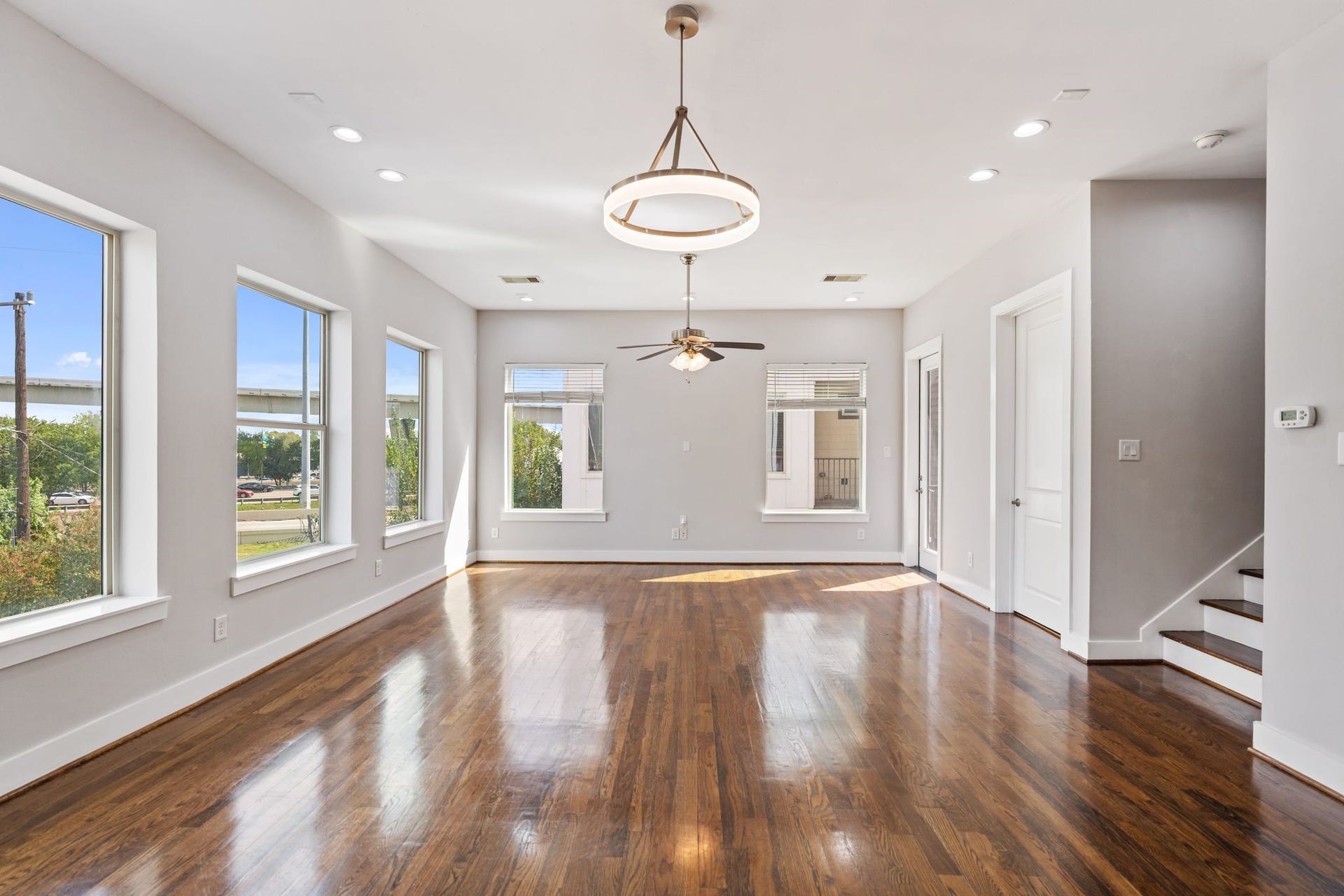 1005 Bingham Street, #5, Houston, TX 77007 Bright living and dining area with large windows, modern light fixtures.