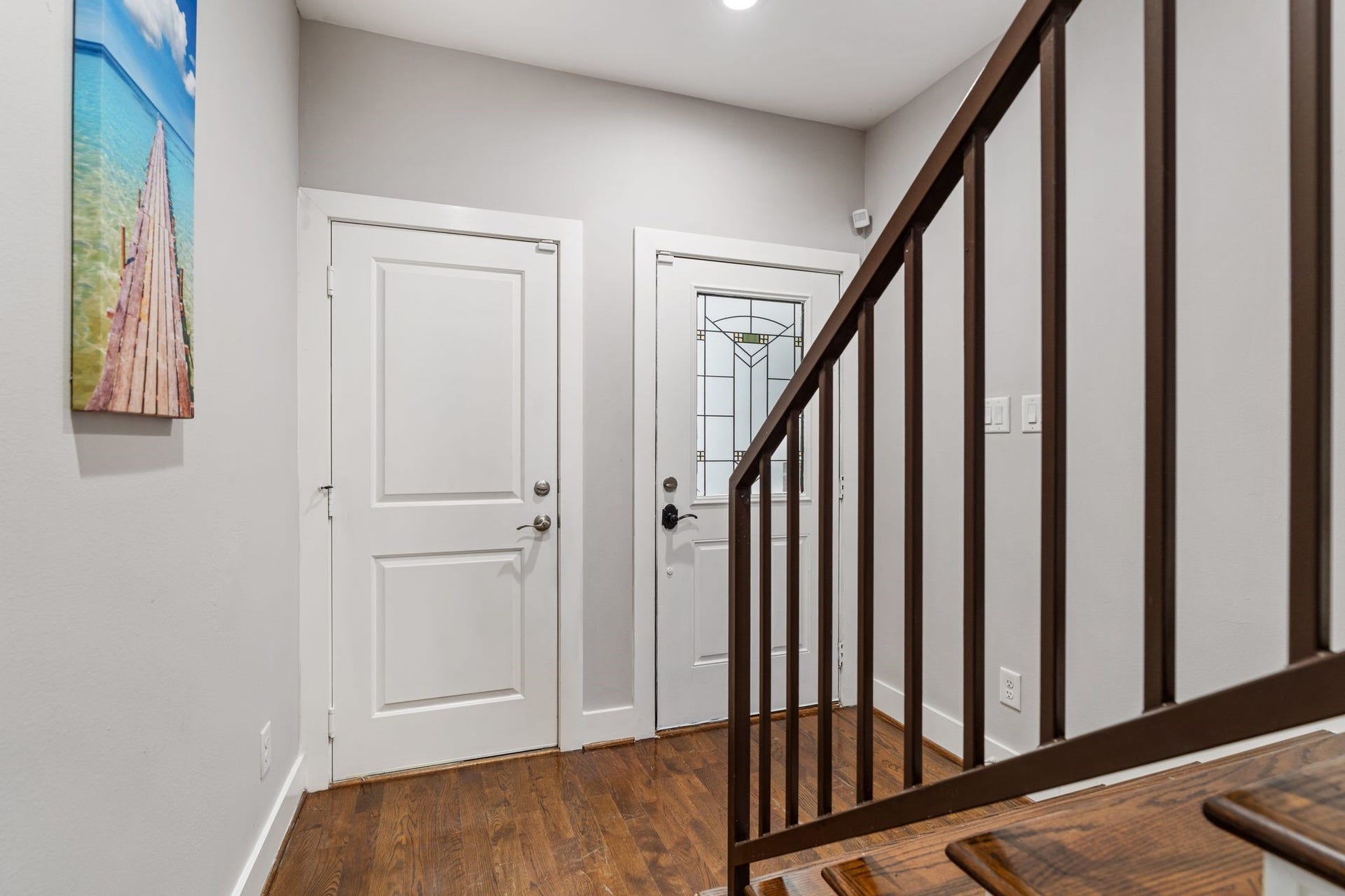 1005 Bingham Street, #5, Houston, TX 77007 Front entry featuring hardwood floors, a glass-paneled front door, and staircase access to the upper levels.