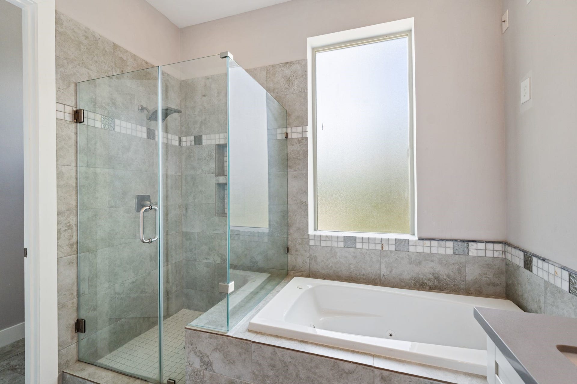 1005 Bingham Street, #5, Houston, TX 77007 Primary bathroom soaking tub with a separate glass-enclosed shower.