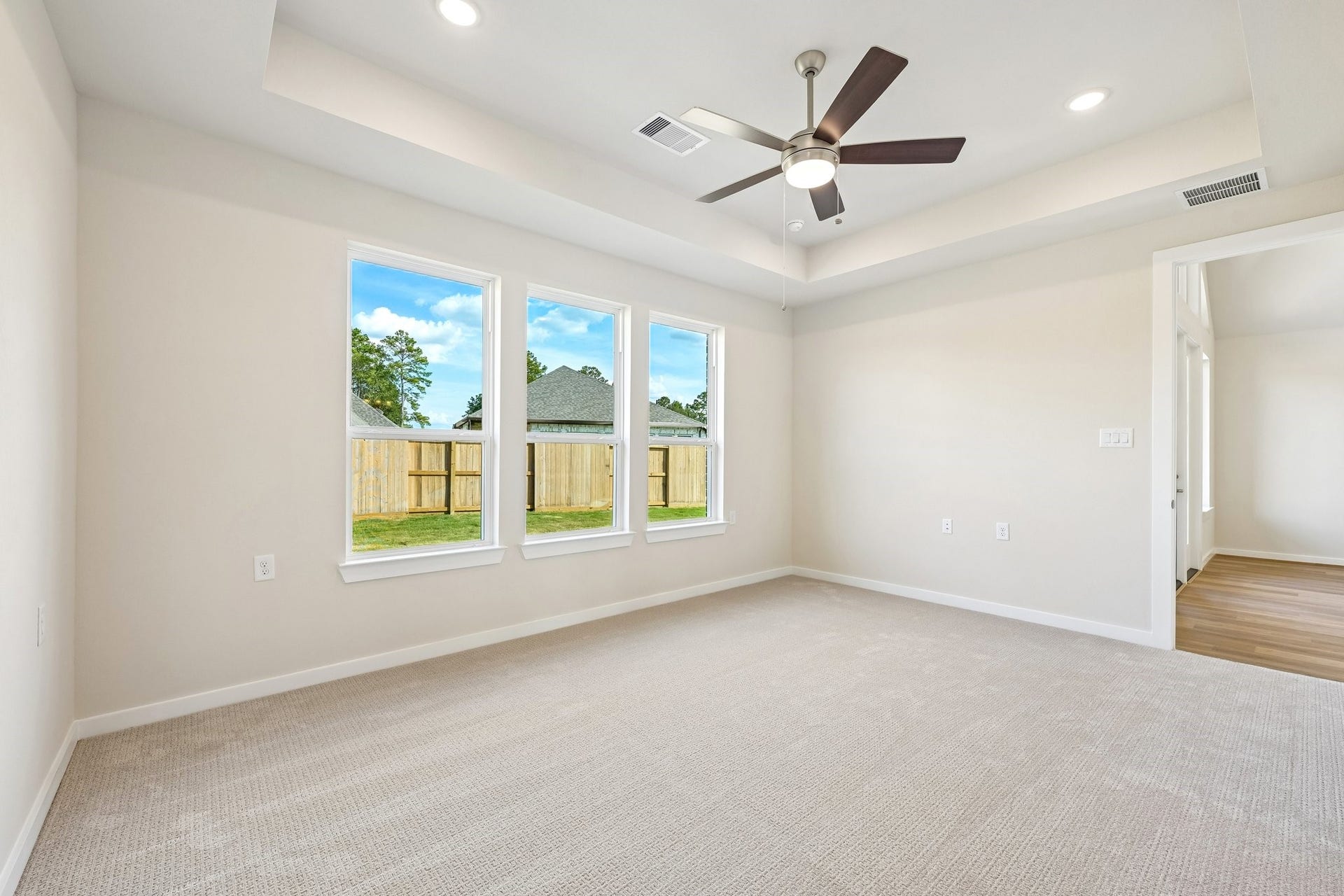 7241 Ironwood Tee Court, Porter, TX 77365 Private primary suite features a tray ceiling, abundant natural light and plenty of room to unwind.
