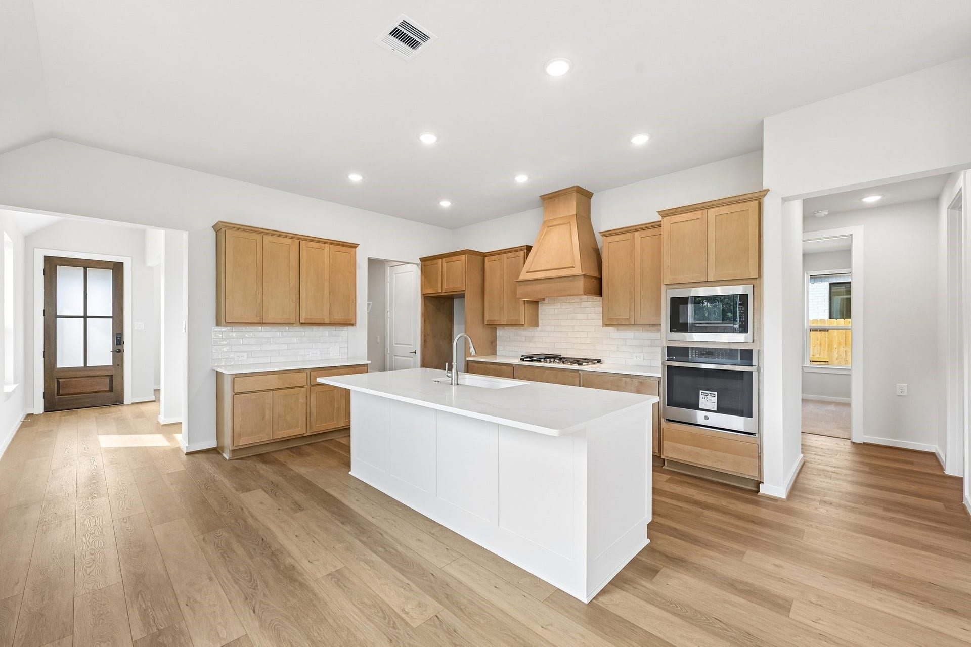 7241 Ironwood Tee Court, Porter, TX 77365 Spacious kitchen with a large center island, walk-in pantry and plenty of cabinetry and counter space.