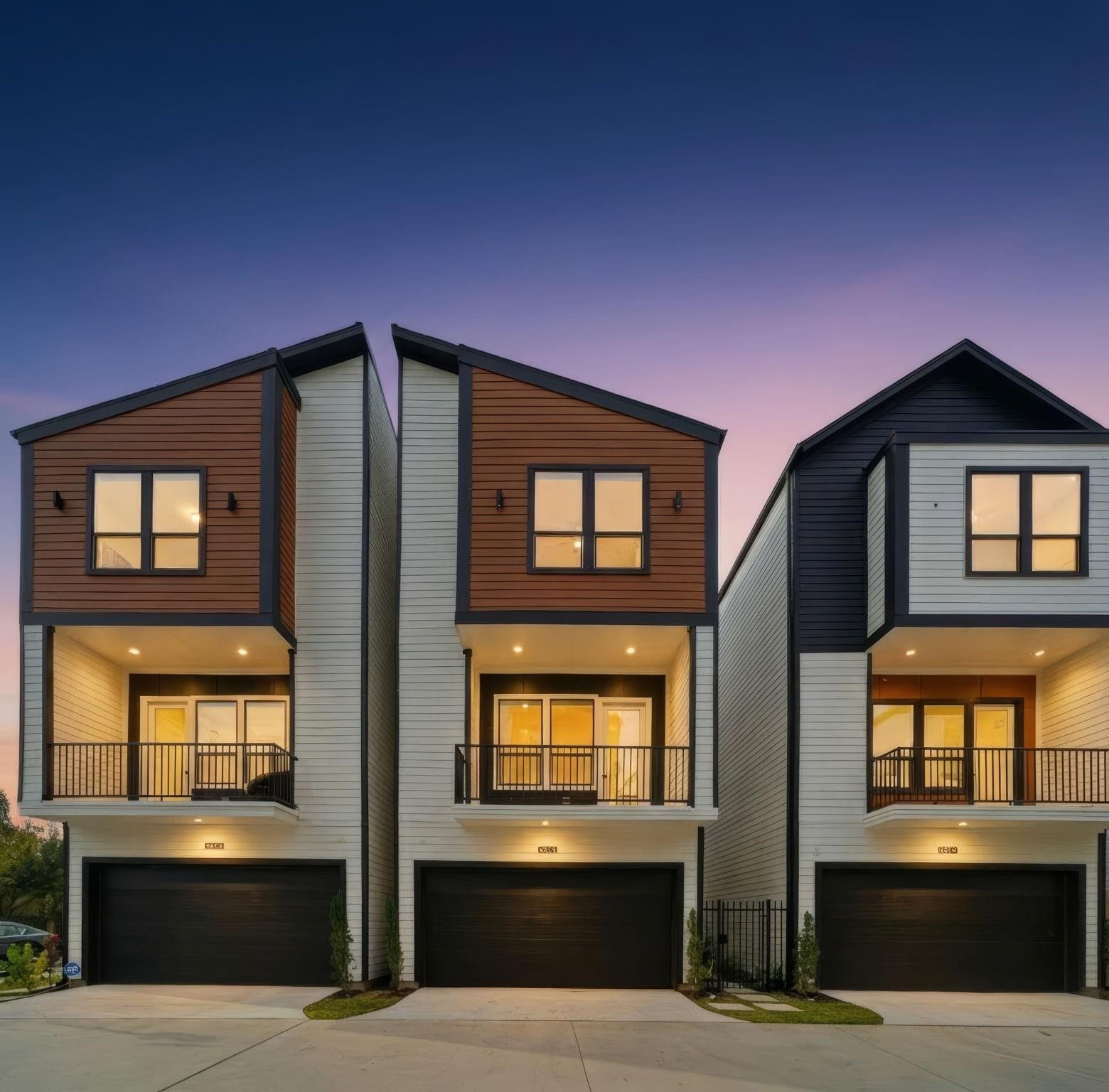 4013 Griggs Road, #F, Houston, TX 77021 Modern tri-level townhomes with sleek design, featuring spacious balconies and two-car garages, set against a serene twilight backdrop.