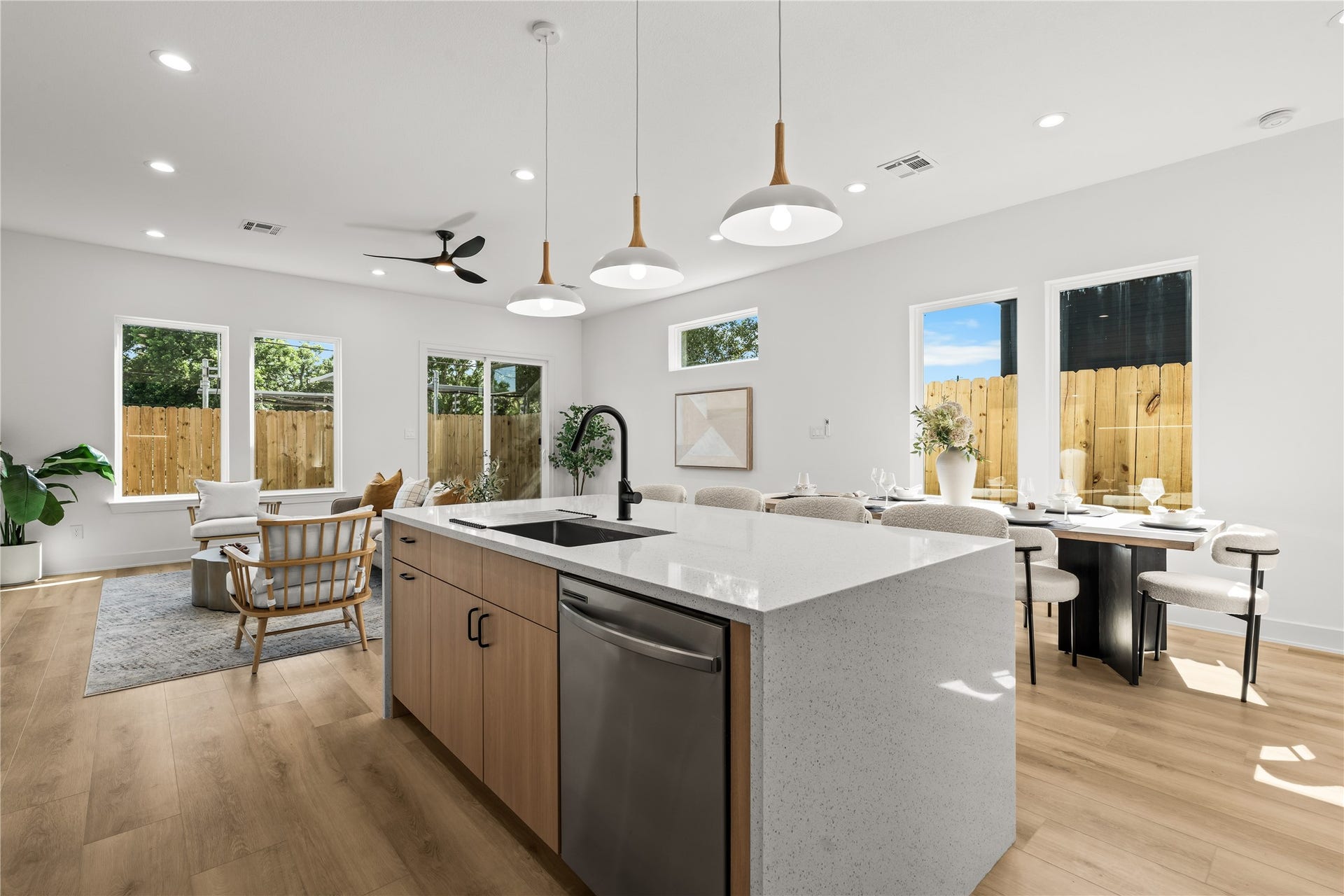 3012 & 3014 Beulah St, Houston, TX 77004 From the kitchen island, you can see how the whole main floor connects. It opens up to a bright dining area on the right and the living room straight ahead. Multiple large windows and the glass back door bring in plenty of natural light throughout the entire space.
