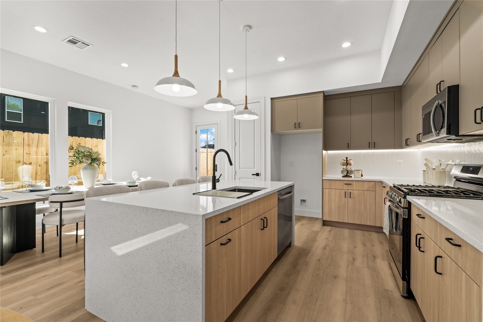 3012 & 3014 Beulah St, Houston, TX 77004 The large kitchen island anchors the room and features a breakfast bar that leads into a separate dining area.