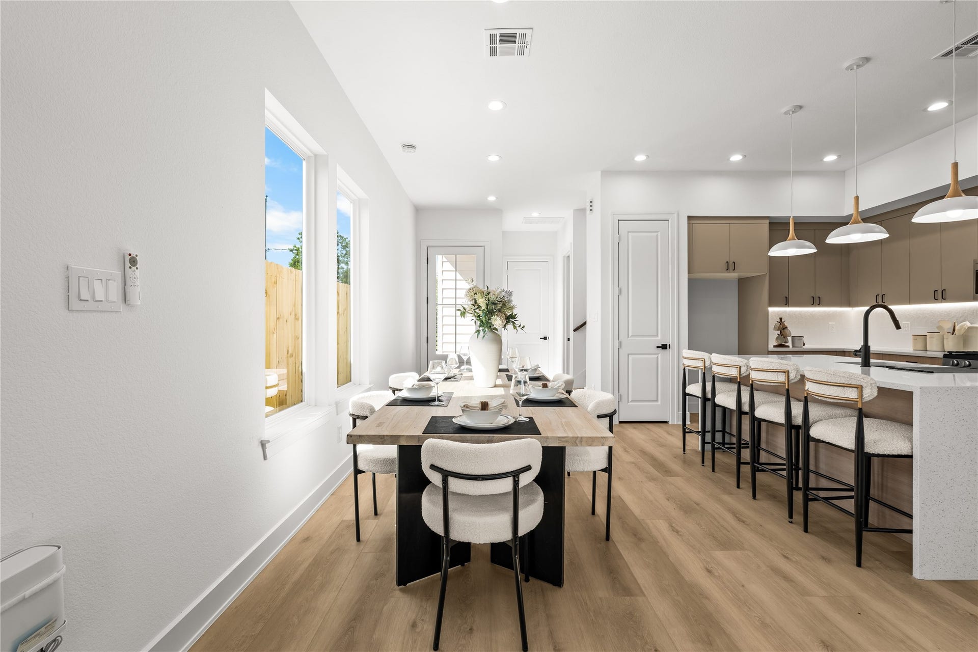 3012 & 3014 Beulah St, Houston, TX 77004 The dining area easily fits a long table and features bright recessed lighting. It sits right off the kitchen, keeping everything connected. Large windows look out into the private, wood-fenced backyard, bringing plenty of natural light into the space.