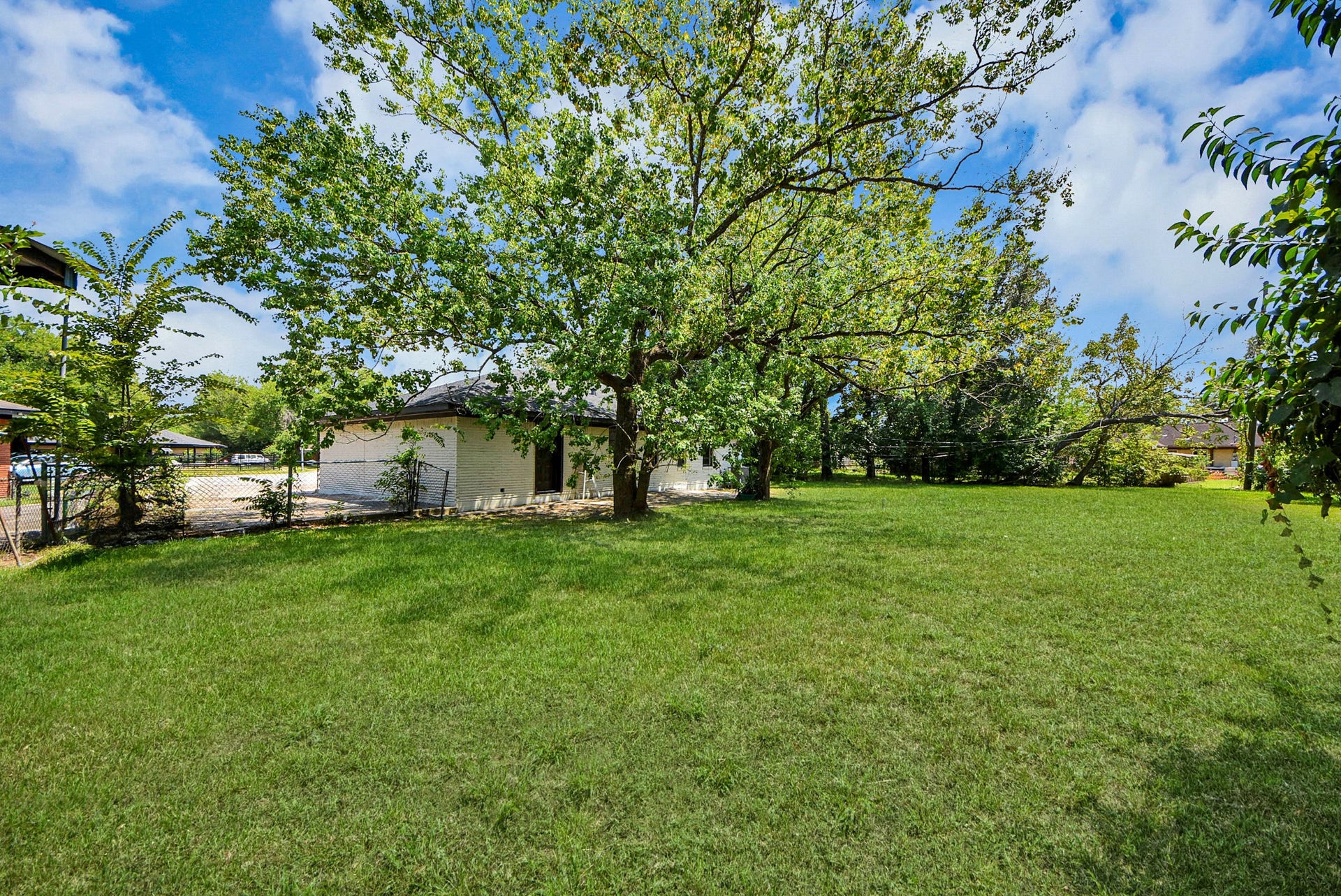 602 Gammon Drive, Houston, TX 77022 Expansive, lush backyard with mature trees offering shade and privacy, perfect for outdoor activities and relaxation.