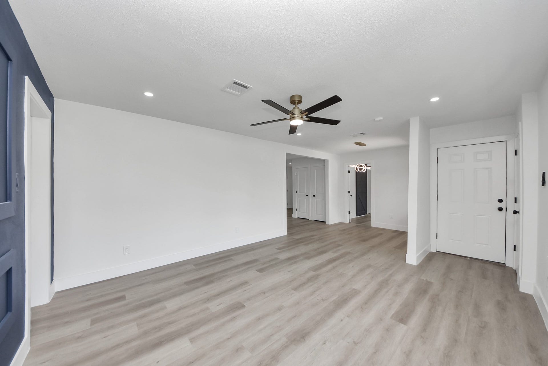 602 Gammon Drive, Houston, TX 77022 Bright, open living area with modern flooring, recessed lighting, and a stylish ceiling fan, offering a welcoming space for relaxation and entertaining.