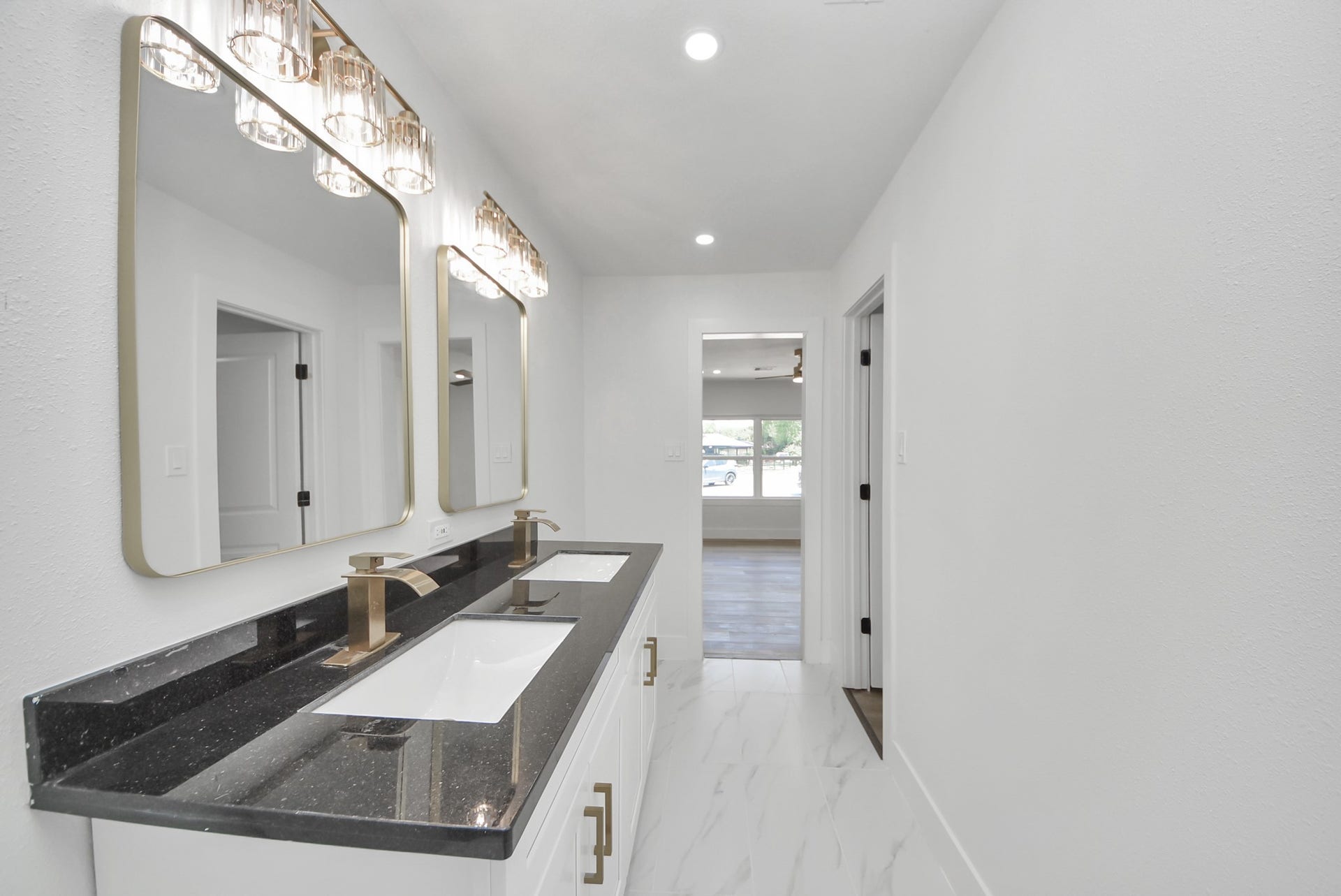 602 Gammon Drive, Houston, TX 77022 Elegant bathroom featuring a sleek double vanity with modern fixtures, chic lighting, and a spacious layout that flows into the main living area.