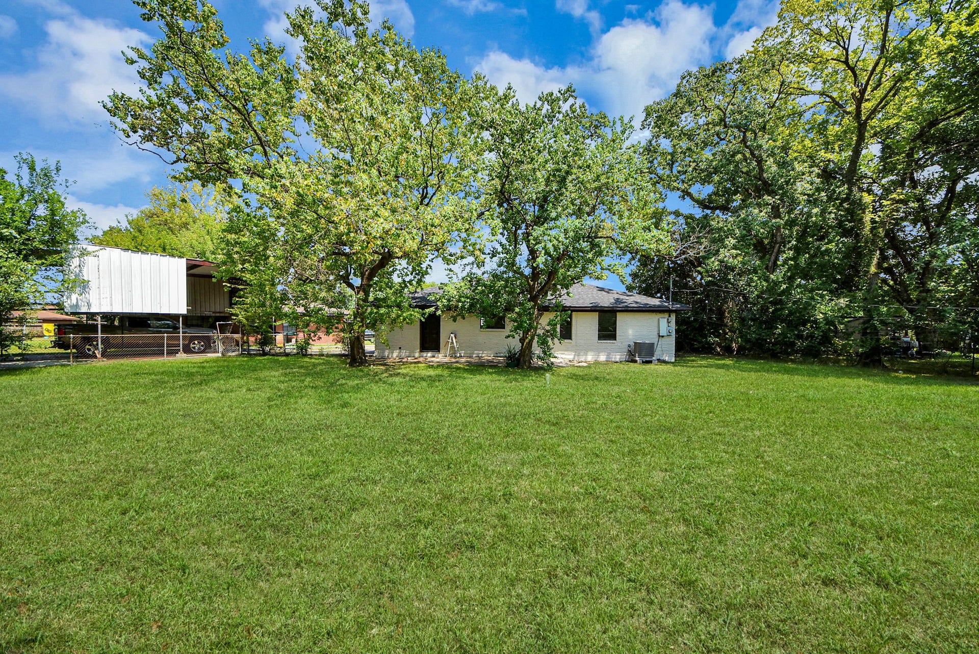 602 Gammon Drive, Houston, TX 77022 Expansive, lush green lawn with mature trees provides a serene, private setting for this charming home.