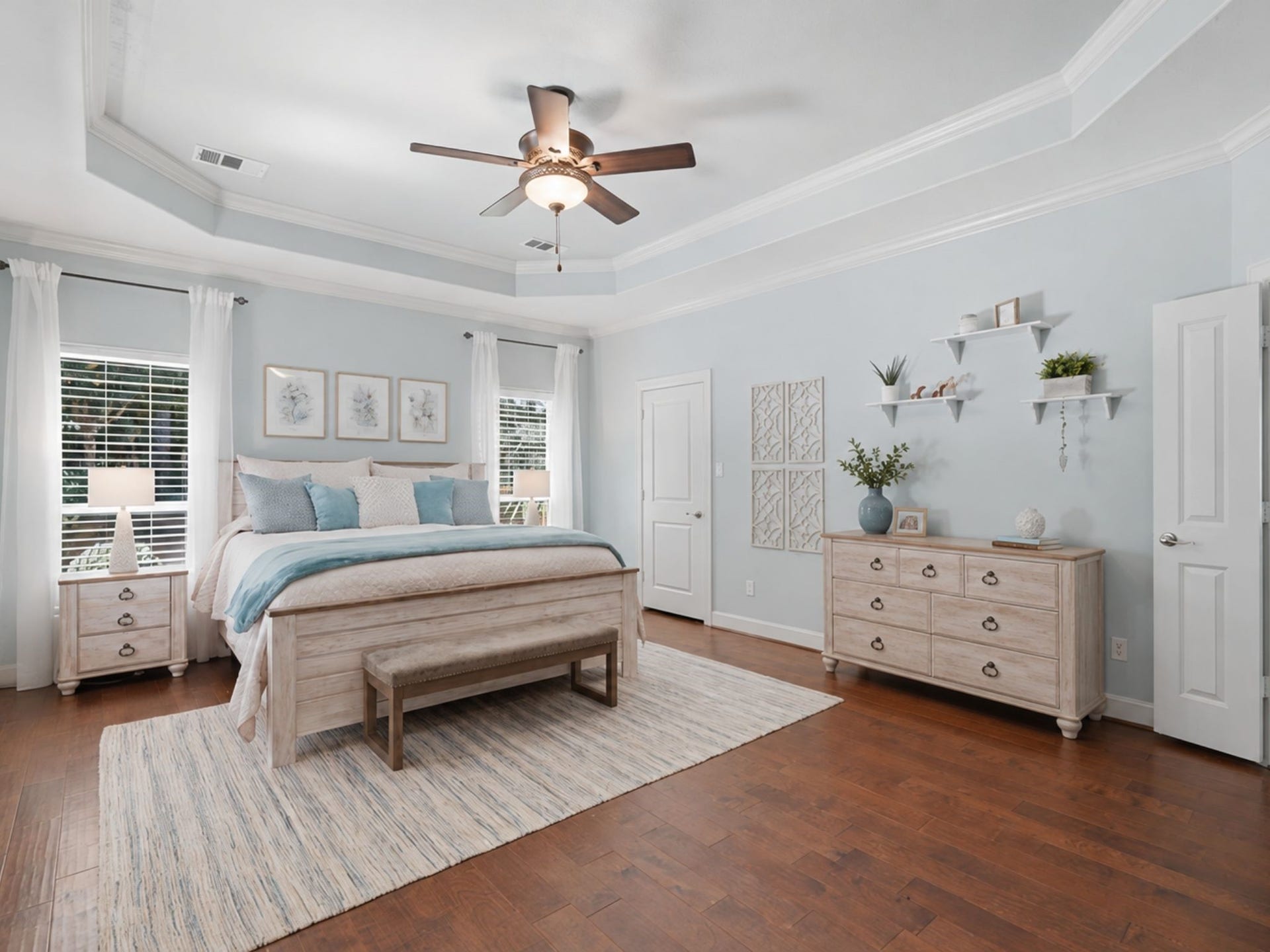 First floor master suite with 2 walk-in closets, double crown molding on ceilings, views of the pool, hardwood floors, French doors to the patio.