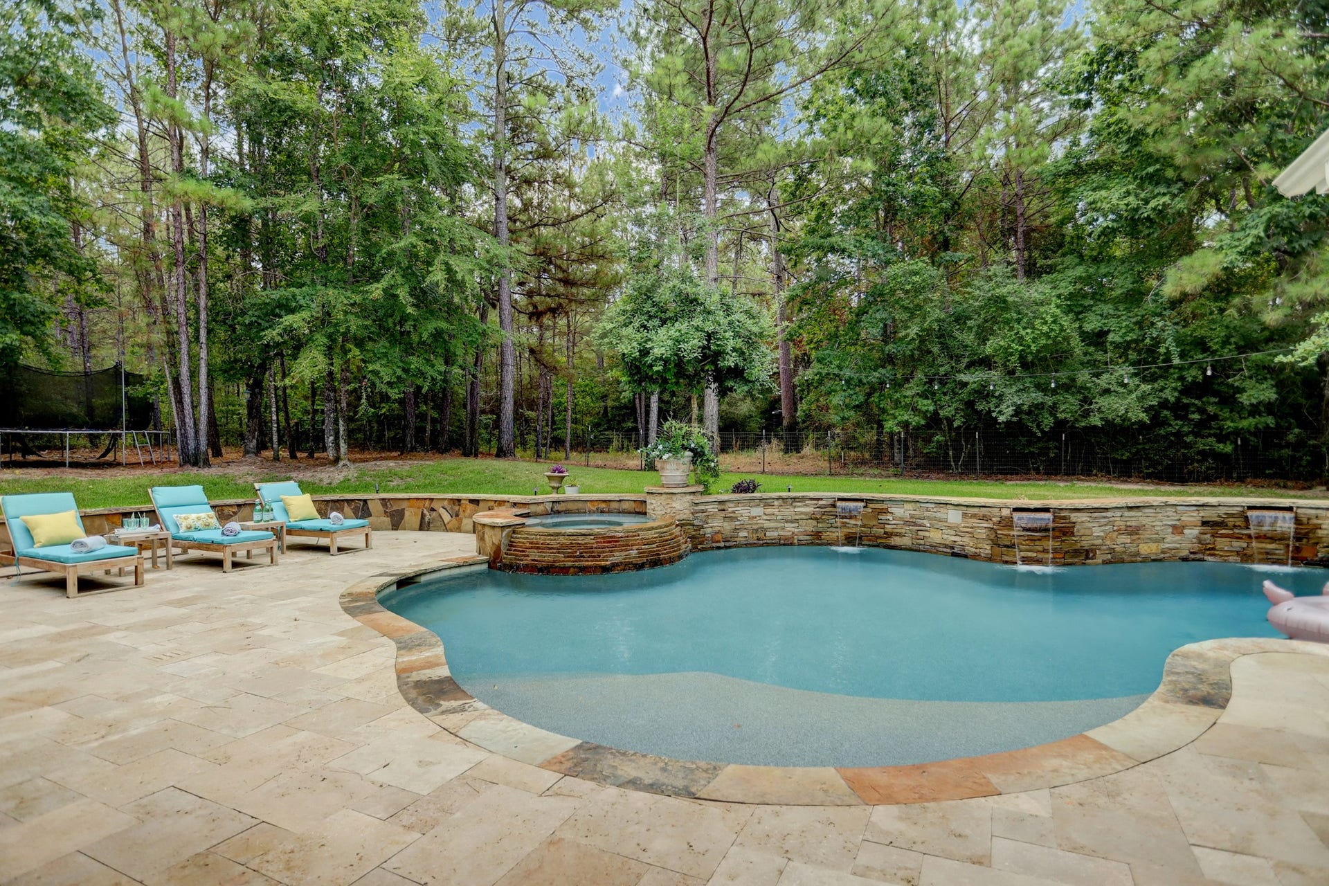 Beautiful pool, hot tub, and acreage backyard is a backyard for dreams.