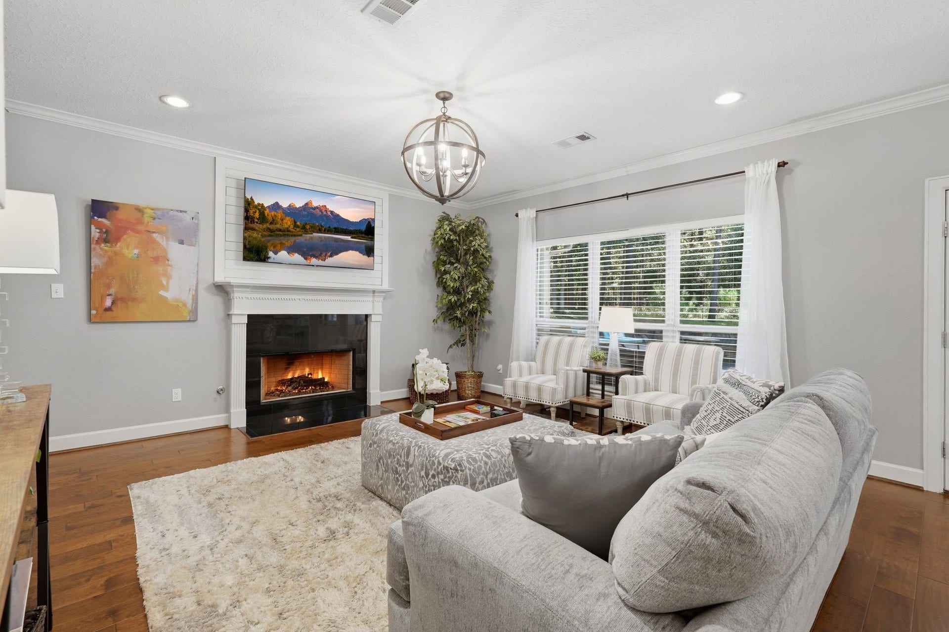 First floor family room with gas fireplace, exterior door to the pool, oversized windows with amazing views of the pool and backyard.