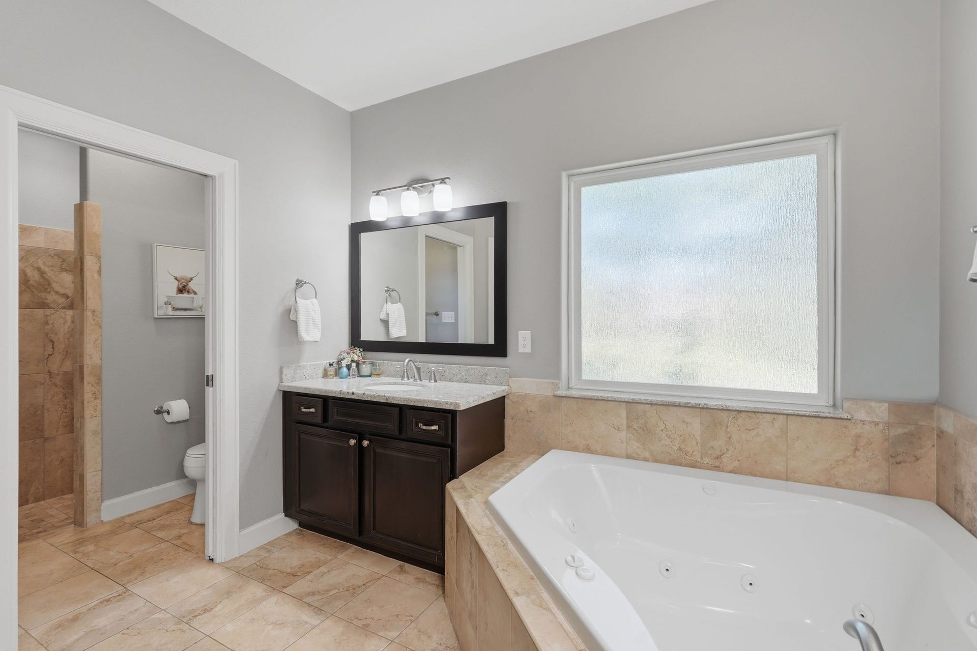 master bathroom, travertine walk-in shower, dual sinks, dual vanities, garden soaking tub, privacy glass window, upgraded lighting, nickel hardware