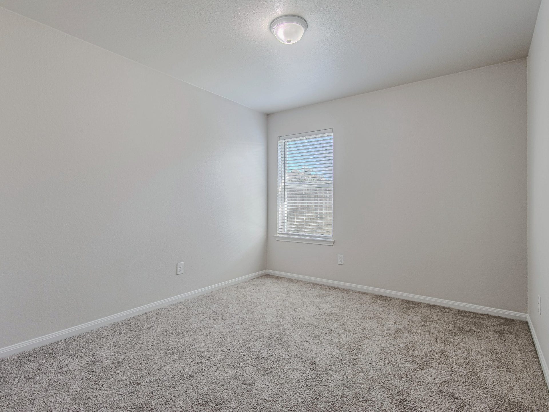 1223 Emerald Stone Drive, Rosharon, TX 77583 This secondary bedroom features carpet flooring, neutral walls, and a window that brings in natural light.
