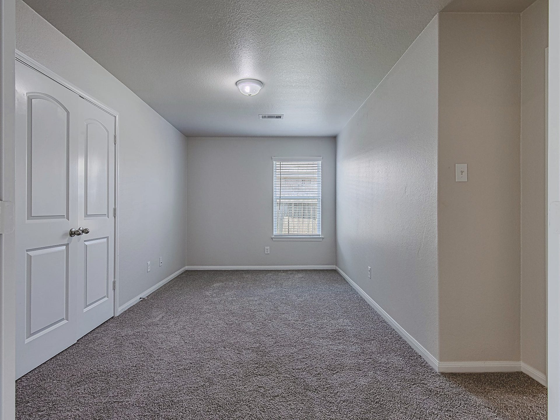 1223 Emerald Stone Drive, Rosharon, TX 77583 This additional carpeted room features a window and closet storage, offering flexible space to suit your needs.