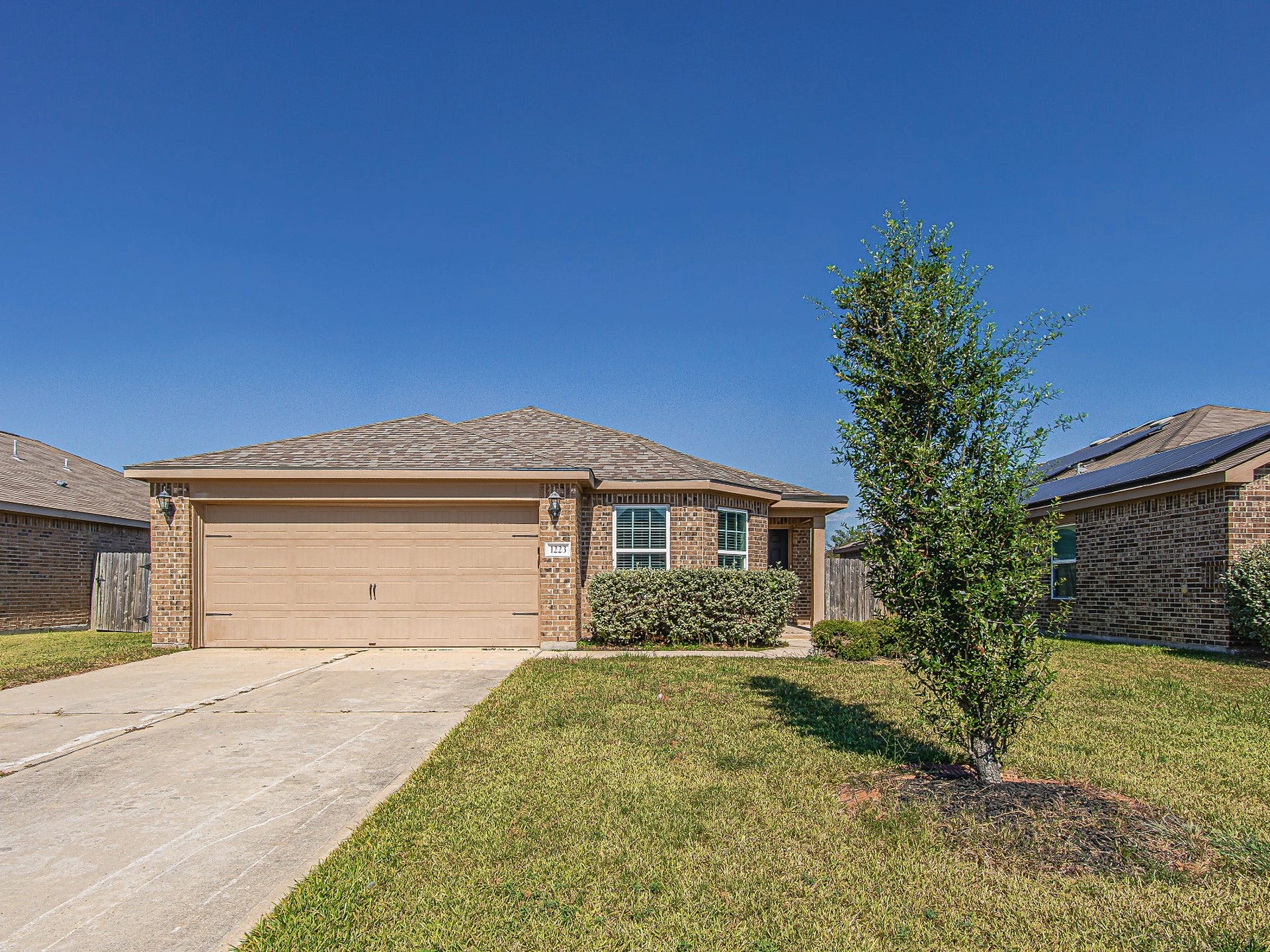 1223 Emerald Stone Drive, Rosharon, TX 77583 Welcome home to this single-story brick residence featuring a two-car garage, a covered front entry, and an inviting front lawn.