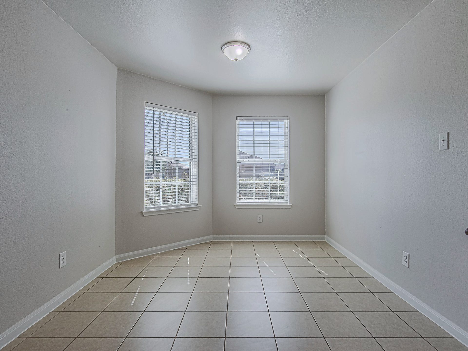 1223 Emerald Stone Drive, Rosharon, TX 77583 Two windows fill the dining nook with natural light, creating a welcoming spot for morning coffee and everyday meals.