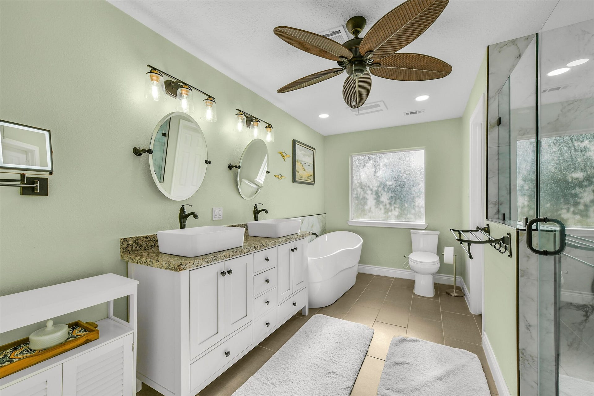 19611 Suncove Lane, Humble, TX 77346 Turn your daily routine into a moment of retreat. Dual vessel sinks, individual mirrors, a freestanding soaking tub and a separate glass-enclosed shower bring distinctive style and thoughtful function to this spacious bath.